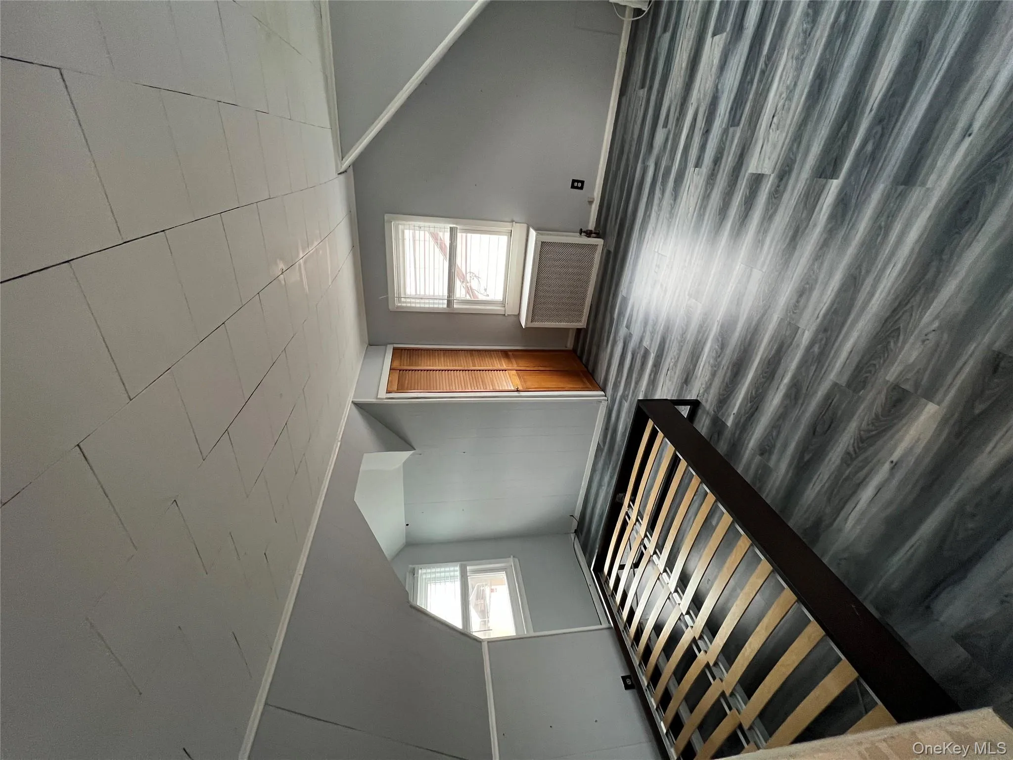 Bonus room with radiator heating unit, wood finished floors, and vaulted ceiling Bonus room with radiator heating unit, wood finished floors, and vaulted ceiling