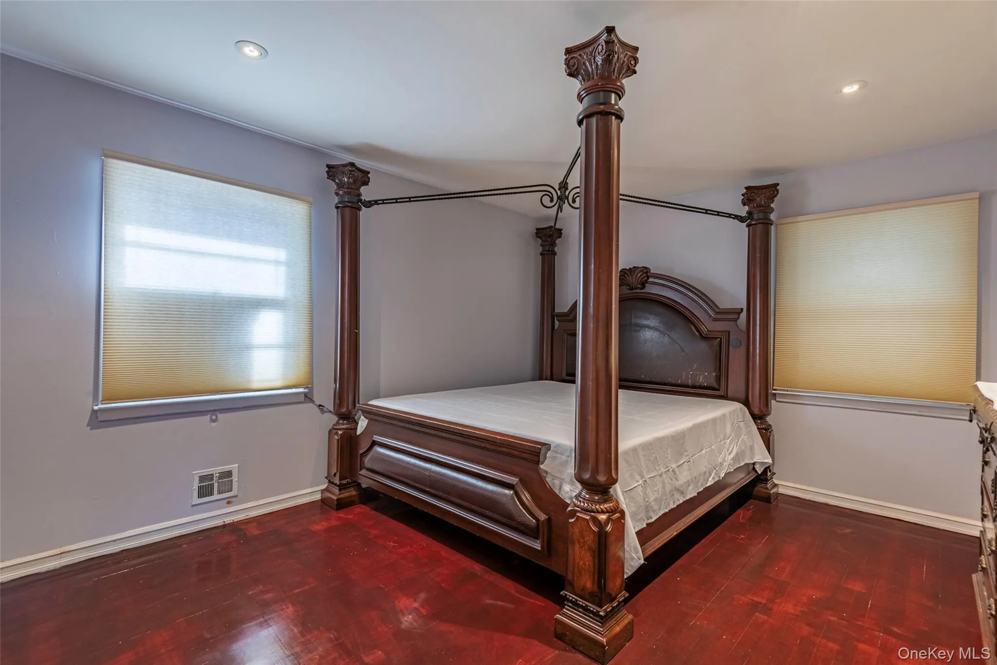 Bedroom featuring dark wood-type flooring and recessed lighting Bedroom featuring dark wood-type flooring and recessed lighting