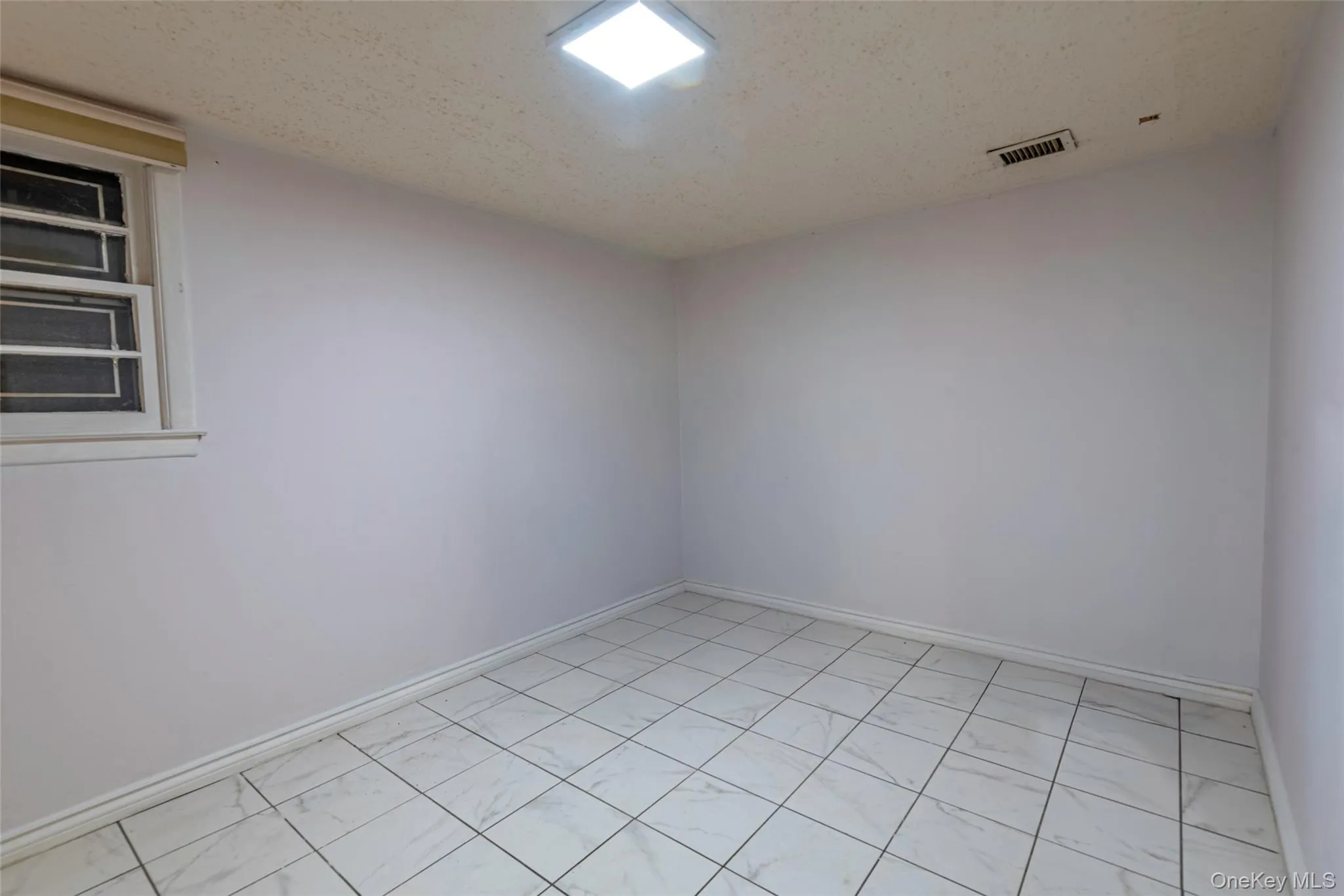 Empty room featuring a textured ceiling Empty room featuring a textured ceiling