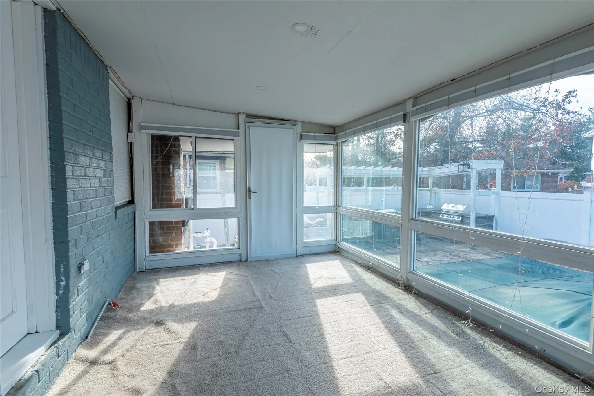 Unfurnished sunroom featuring vaulted ceiling Unfurnished sunroom featuring vaulted ceiling
