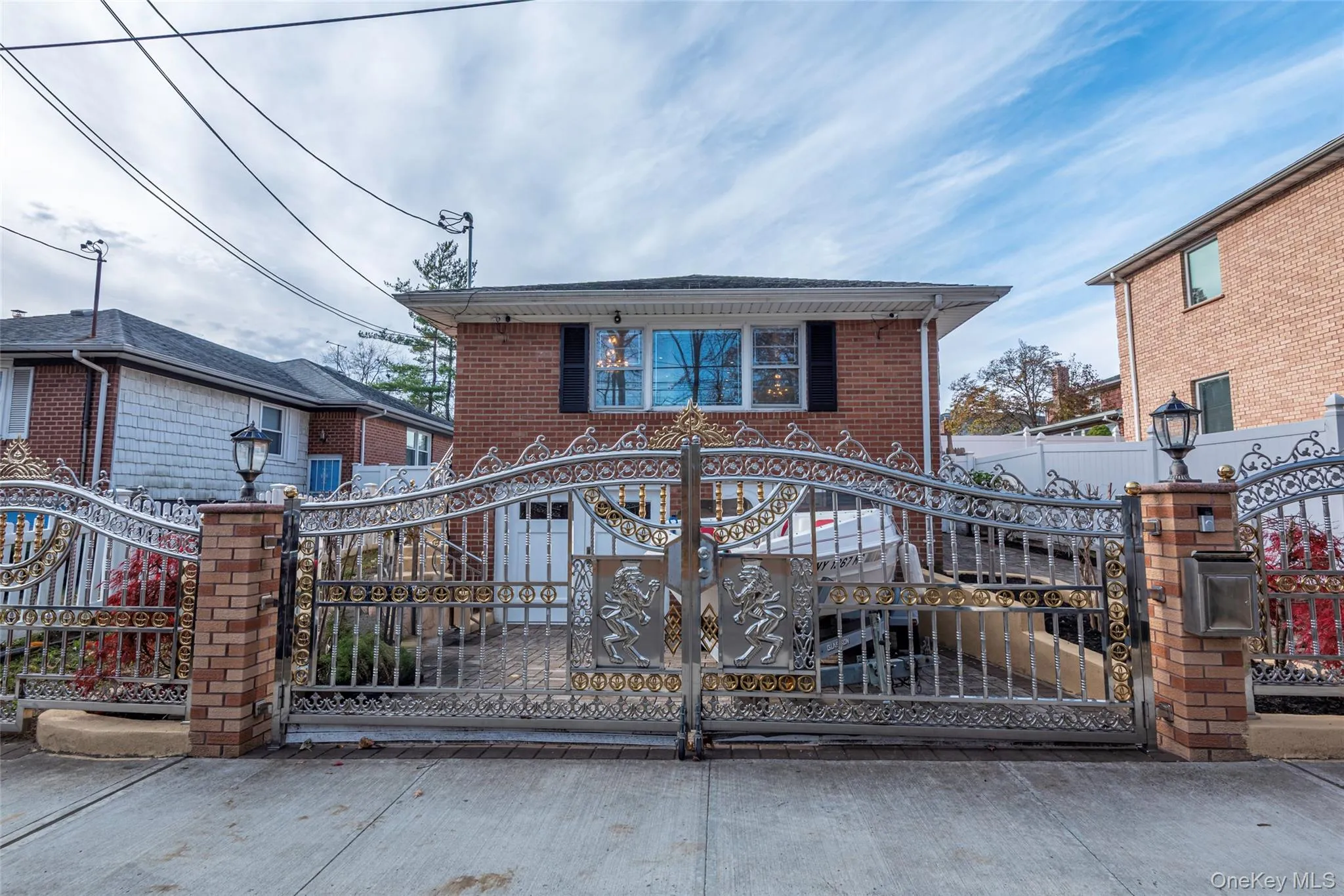 View of front of property featuring a gate, brick siding, and a fenced front yard View of front of property featuring a gate, brick siding, and a fenced front yard