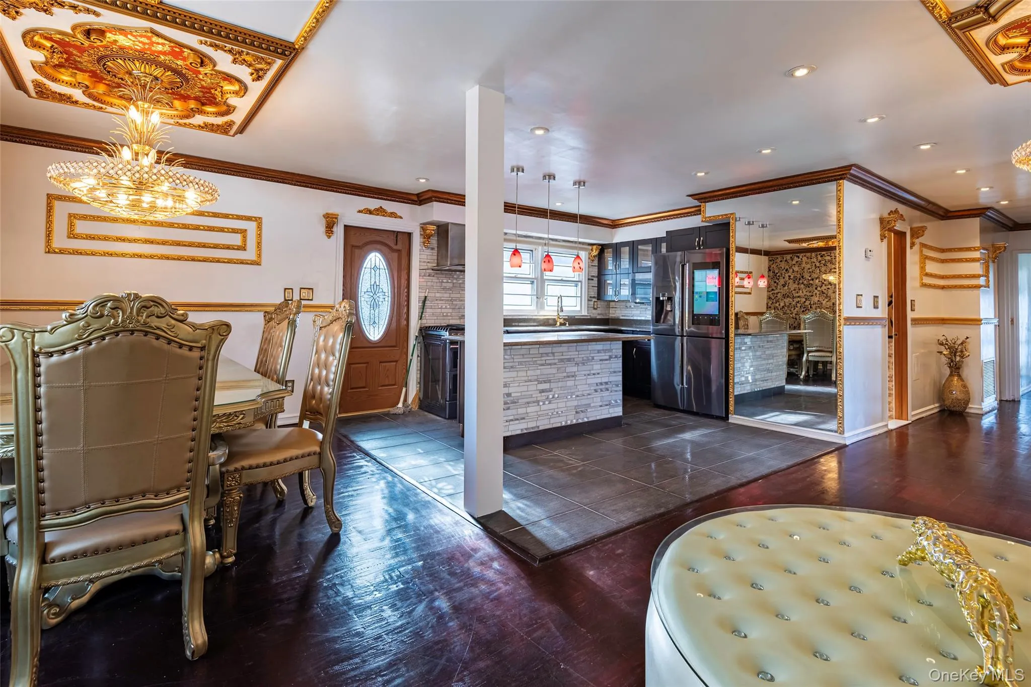 Dining space featuring dark wood-style floors, crown molding, and a chandelier Dining space featuring dark wood-style floors, crown molding, and a chandelier