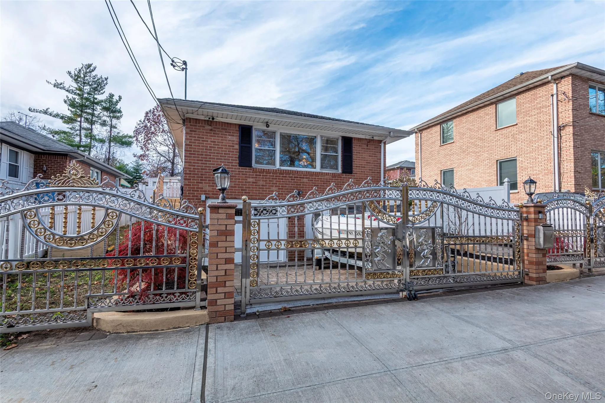 View of front facade with a gate, brick siding, and a fenced front yard View of front facade with a gate, brick siding, and a fenced front yard