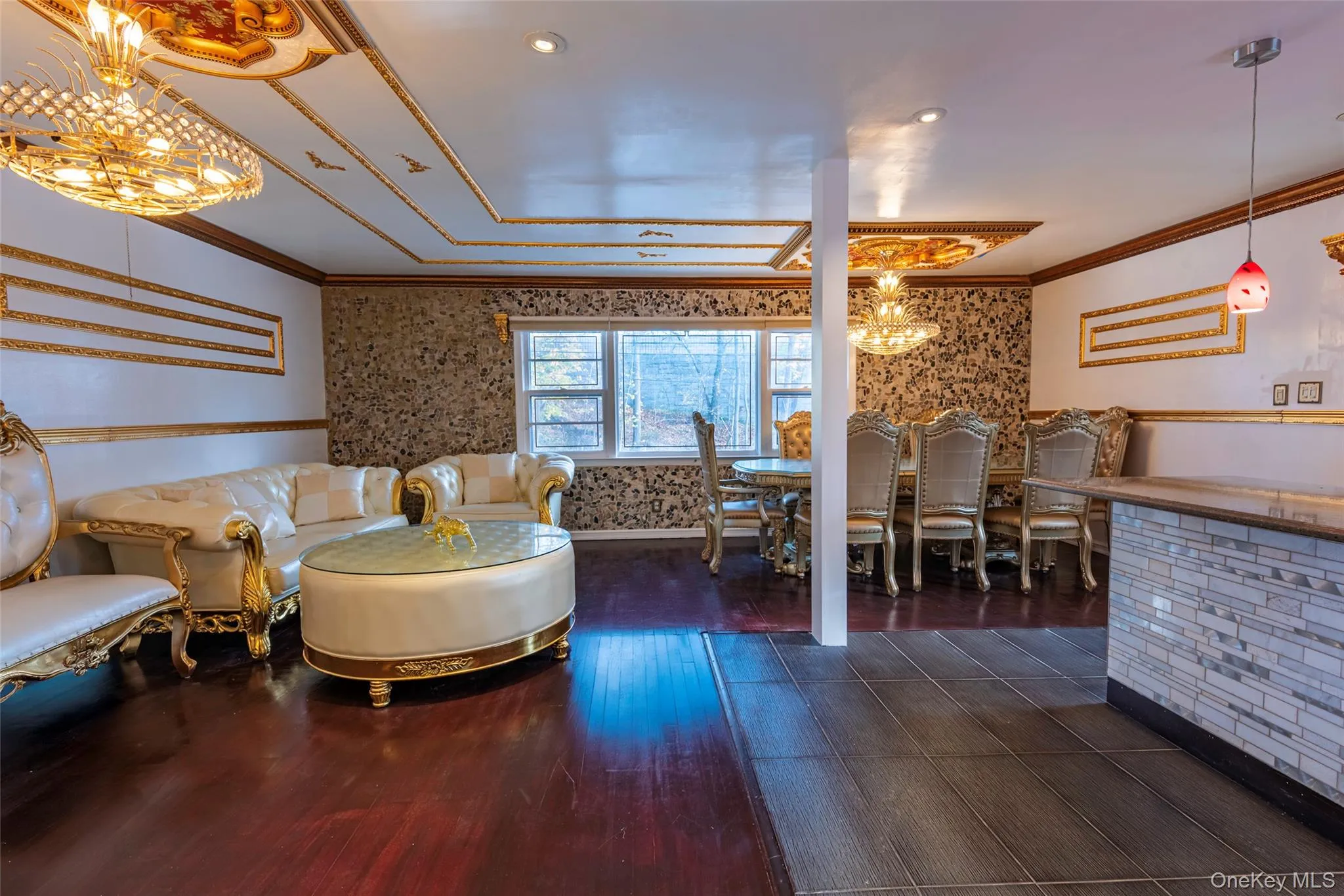 Living area with a chandelier, crown molding, dark wood finished floors, wallpapered walls, and recessed lighting Living area with a chandelier, crown molding, dark wood finished floors, wallpapered walls, and recessed lighting