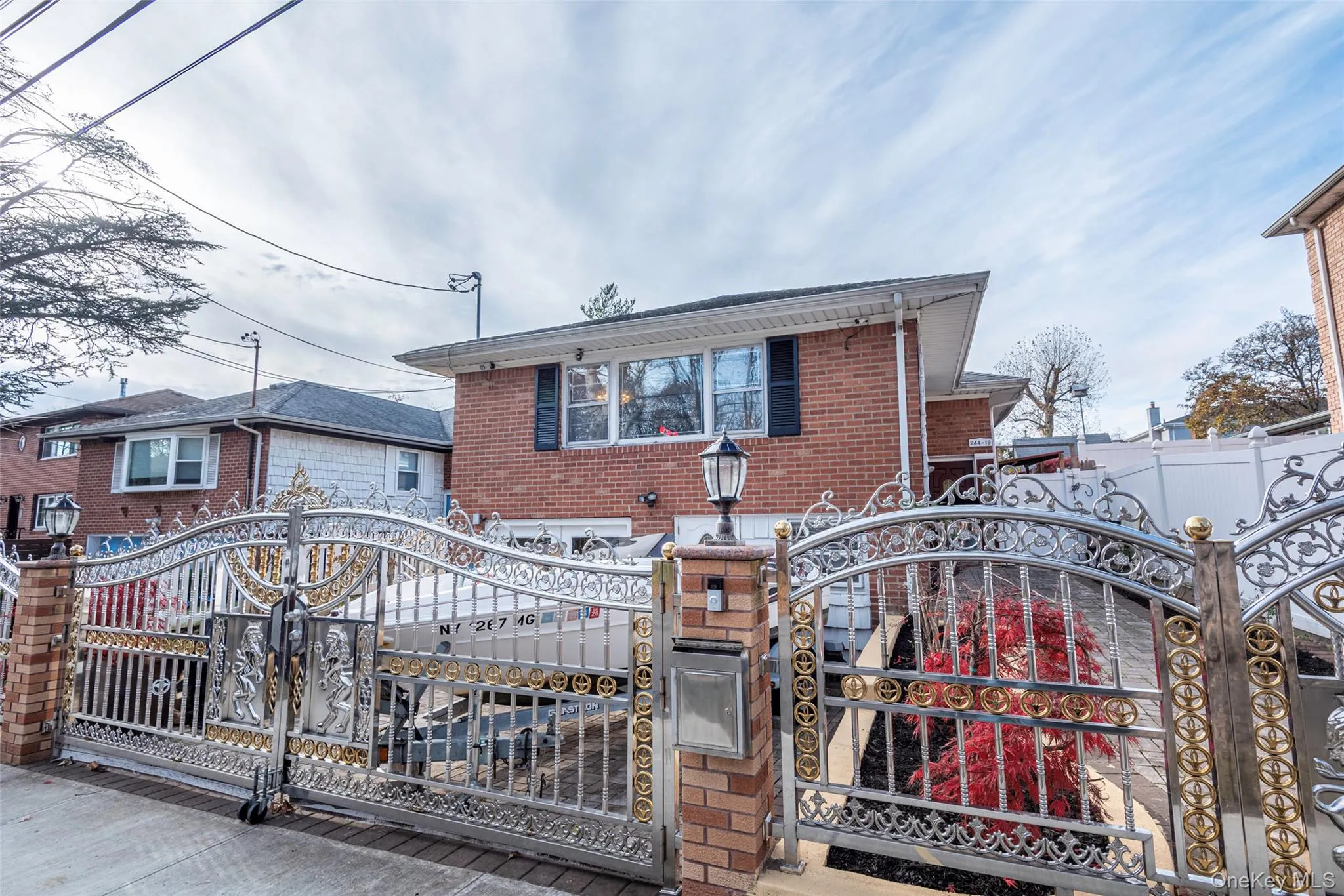 View of front of property with a fenced front yard, a gate, and brick siding View of front of property with a fenced front yard, a gate, and brick siding