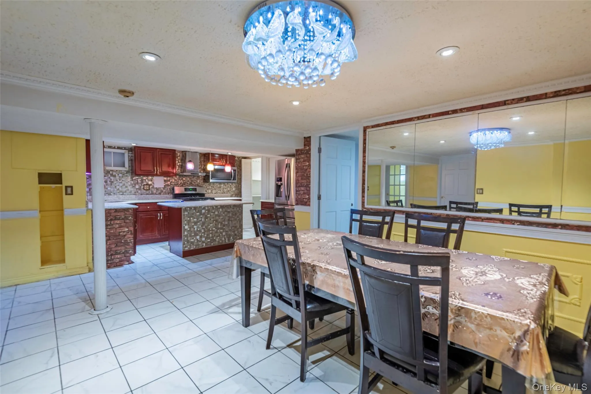 Dining area with a chandelier, ornamental molding, light tile patterned flooring, a textured ceiling, and recessed lighting Dining area with a chandelier, ornamental molding, light tile patterned flooring, a textured ceiling, and recessed lighting