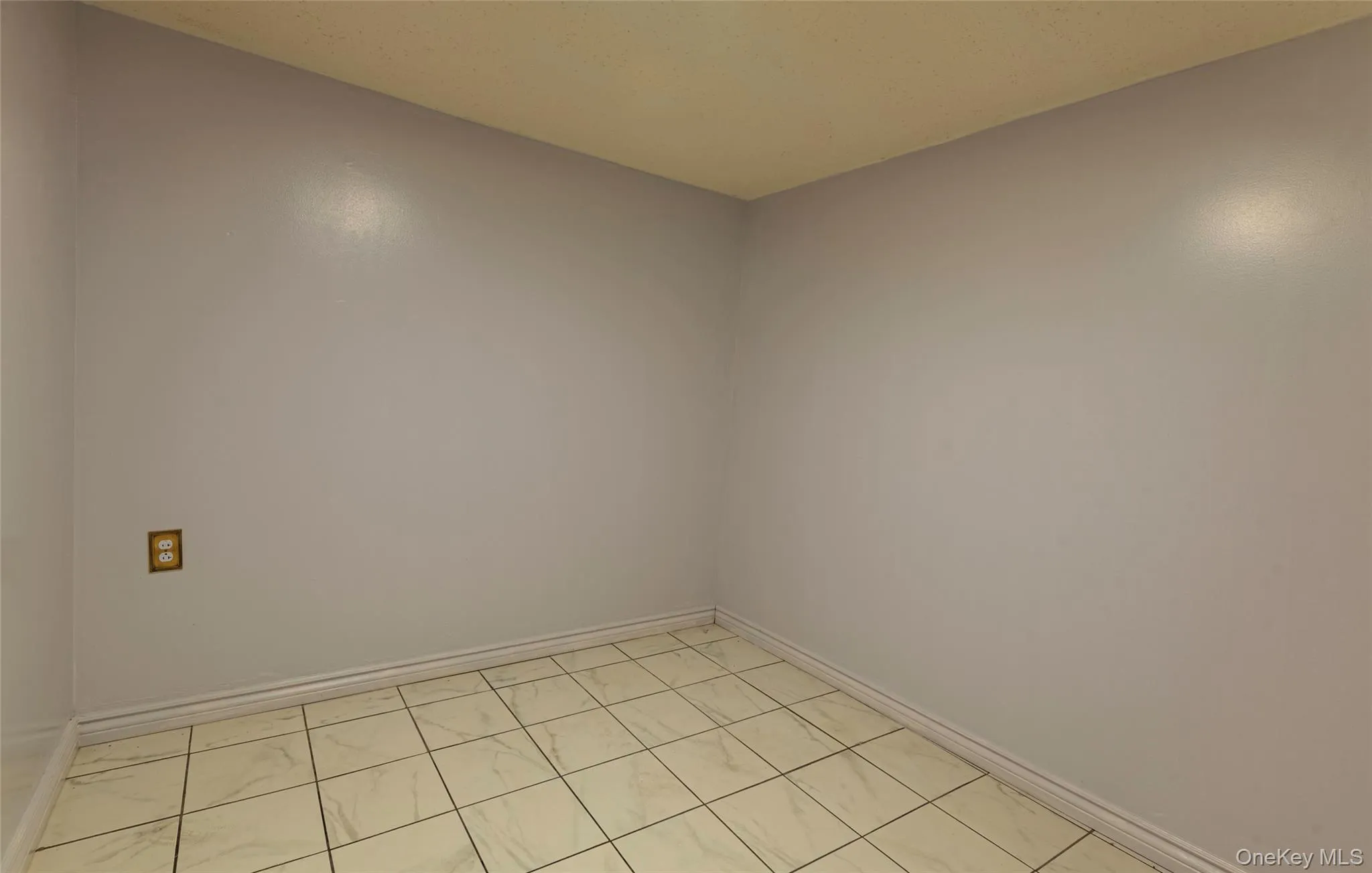 Spare room with baseboards and light tile patterned floors Spare room with baseboards and light tile patterned floors