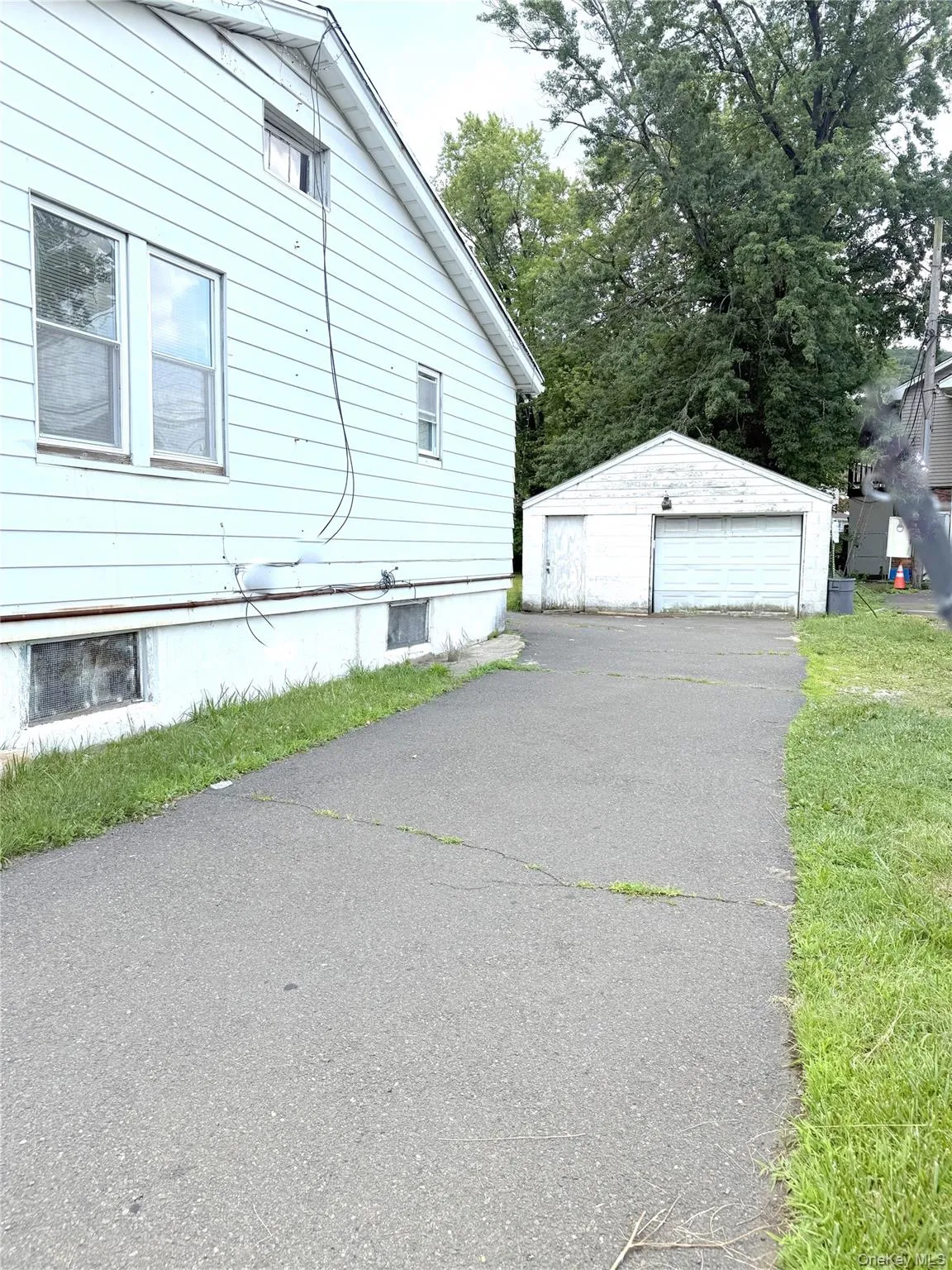 View of home's exterior featuring a garage and an outdoor structure View of home's exterior featuring a garage and an outdoor structure