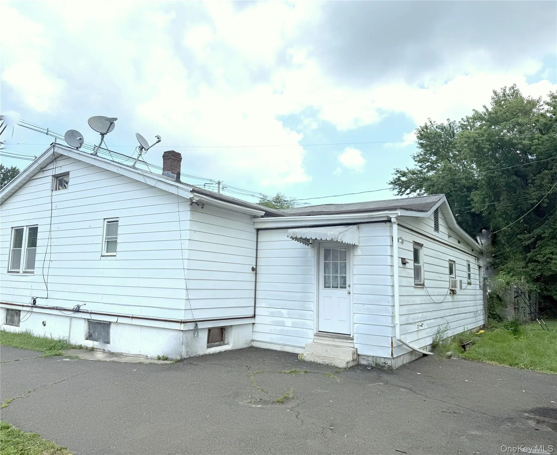 Rear view of house with a chimney and entry steps Rear view of house with a chimney and entry steps
