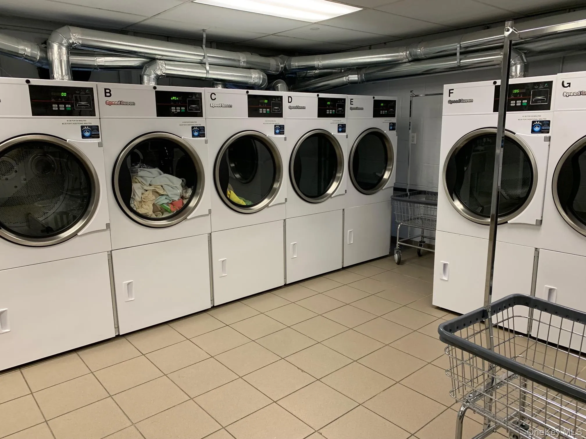 Laundry room with separate washer and dryer and a paneled ceiling Laundry room with separate washer and dryer and a paneled ceiling