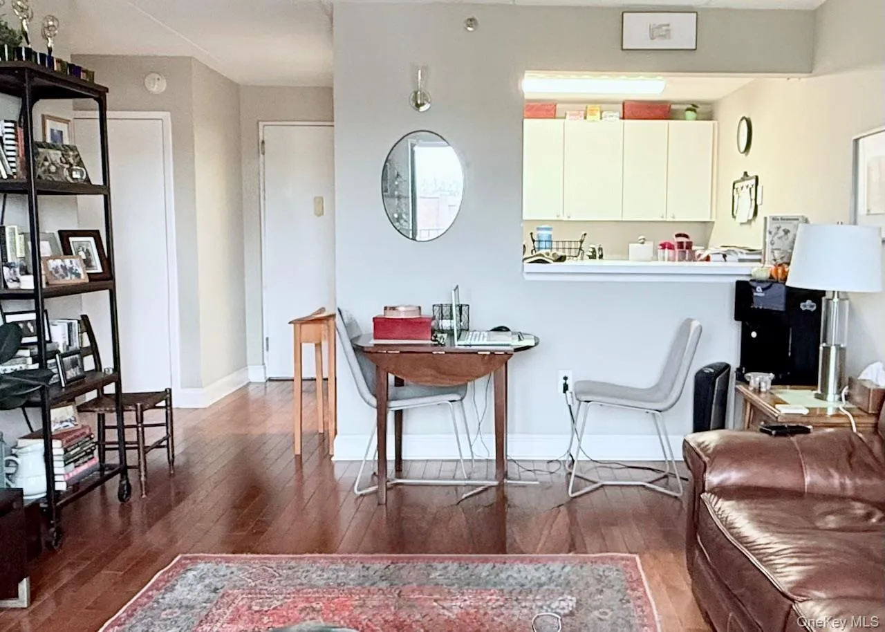 Living room featuring dark wood-style floors and baseboards Living room featuring dark wood-style floors and baseboards