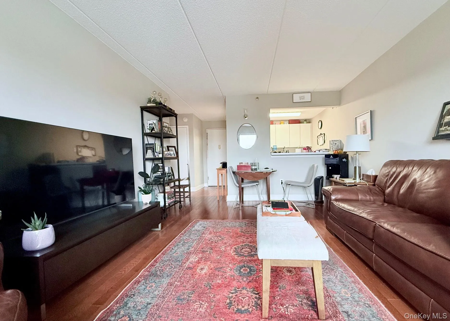 Living area with wood finished floors and a textured ceiling Living area with wood finished floors and a textured ceiling