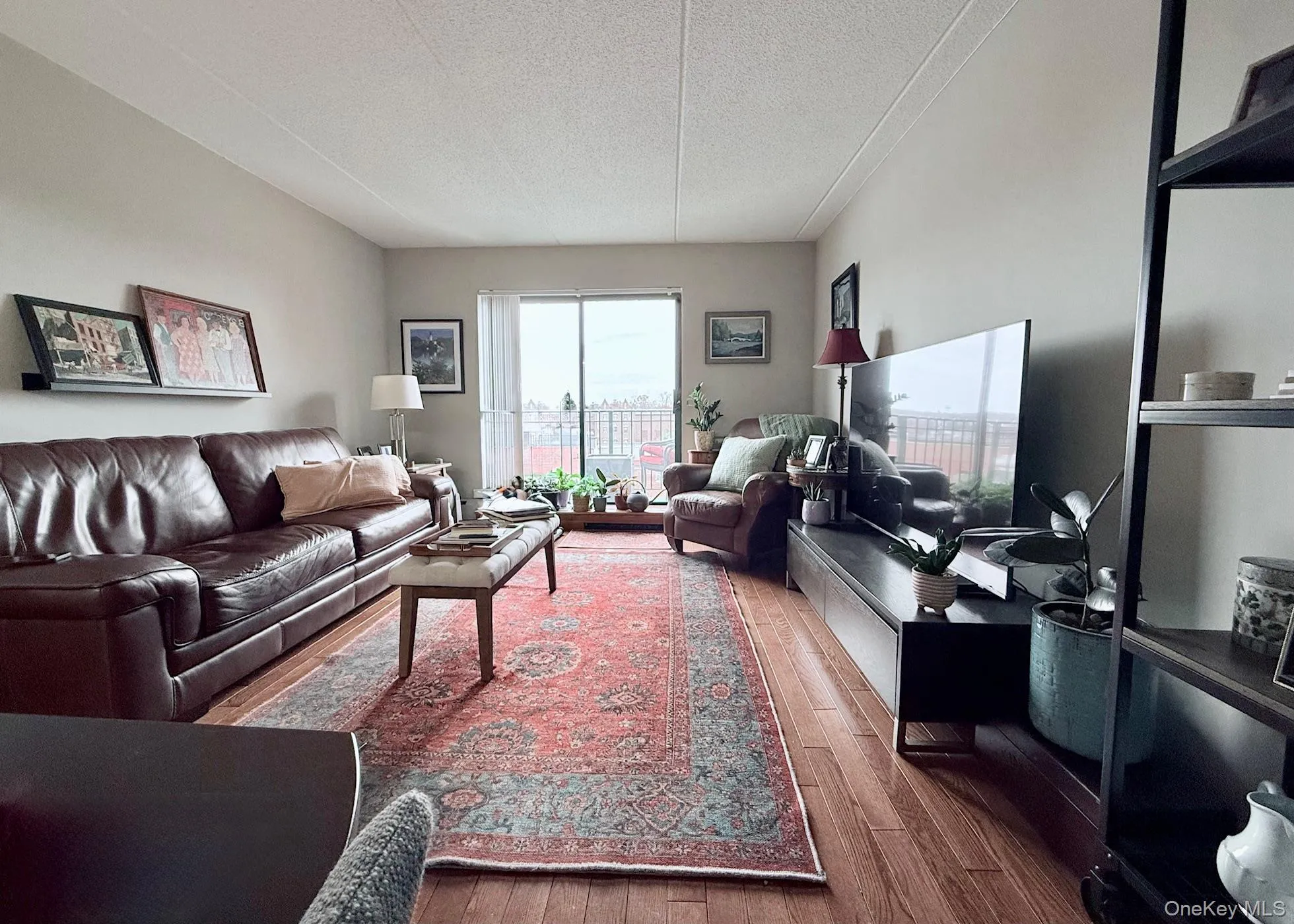 Living room featuring a textured ceiling and wood finished floors Living room featuring a textured ceiling and wood finished floors