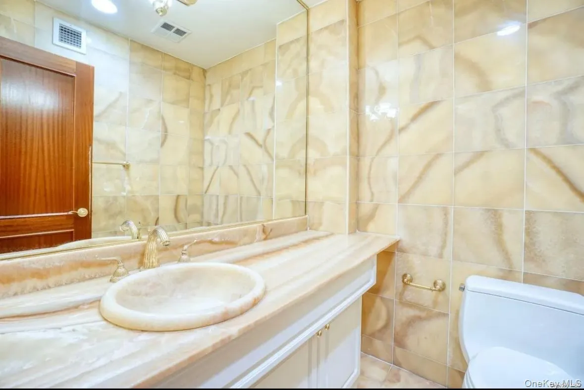 Bathroom with tile walls and vanity Bathroom with tile walls and vanity