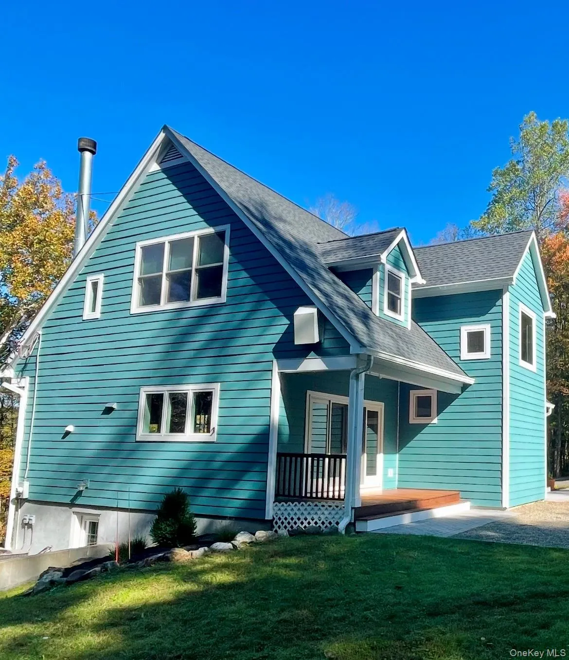 Rear view of property featuring a lawn, roof with shingles, and covered porch Rear view of property featuring a lawn, roof with shingles, and covered porch