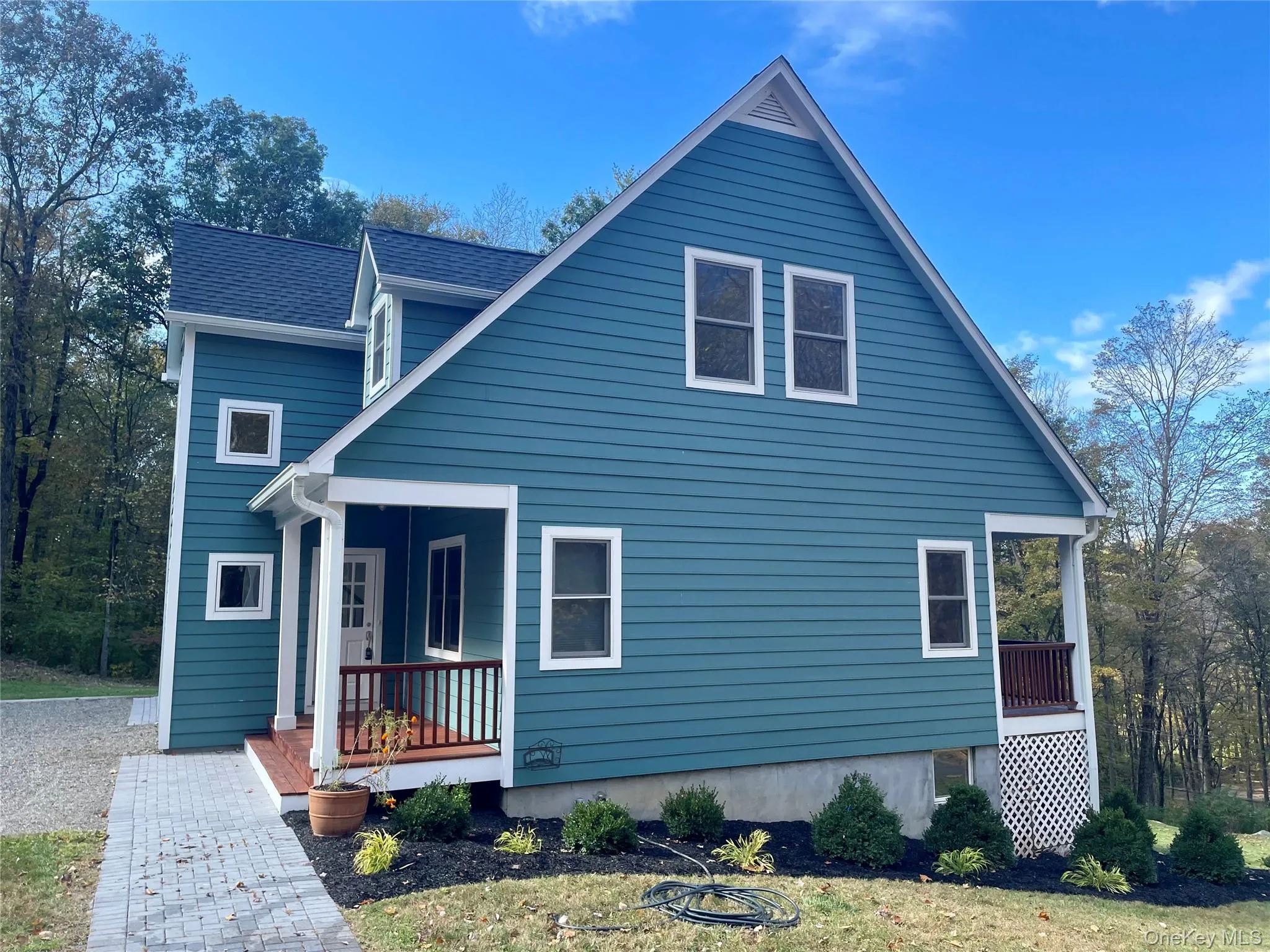 View of back of property featuring roof with shingles and covered porch View of back of property featuring roof with shingles and covered porch
