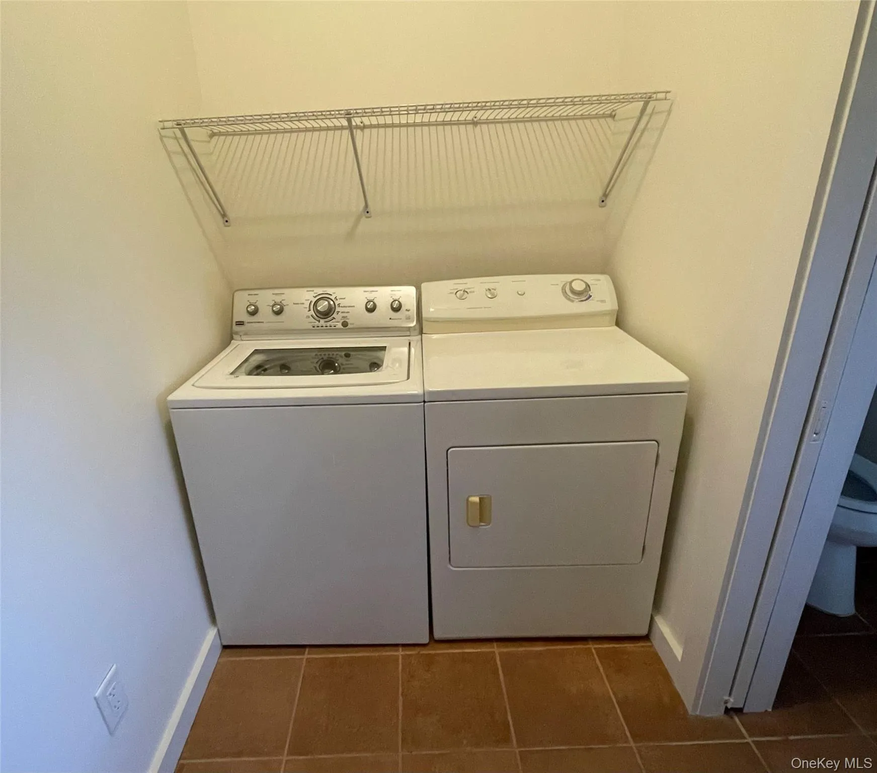 Washroom featuring washing machine and clothes dryer Washroom featuring washing machine and clothes dryer