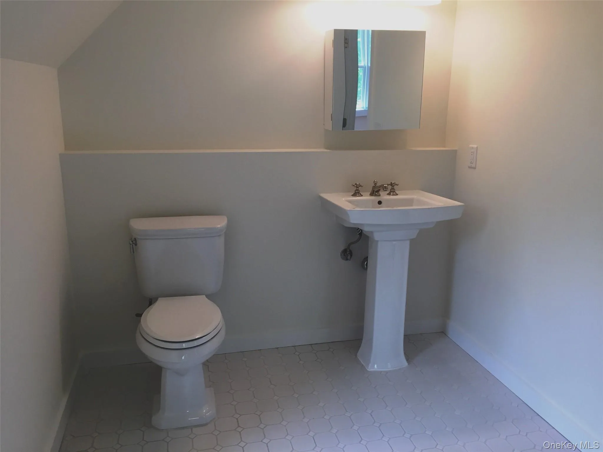 Half bathroom featuring toilet and a sink Half bathroom featuring toilet and a sink