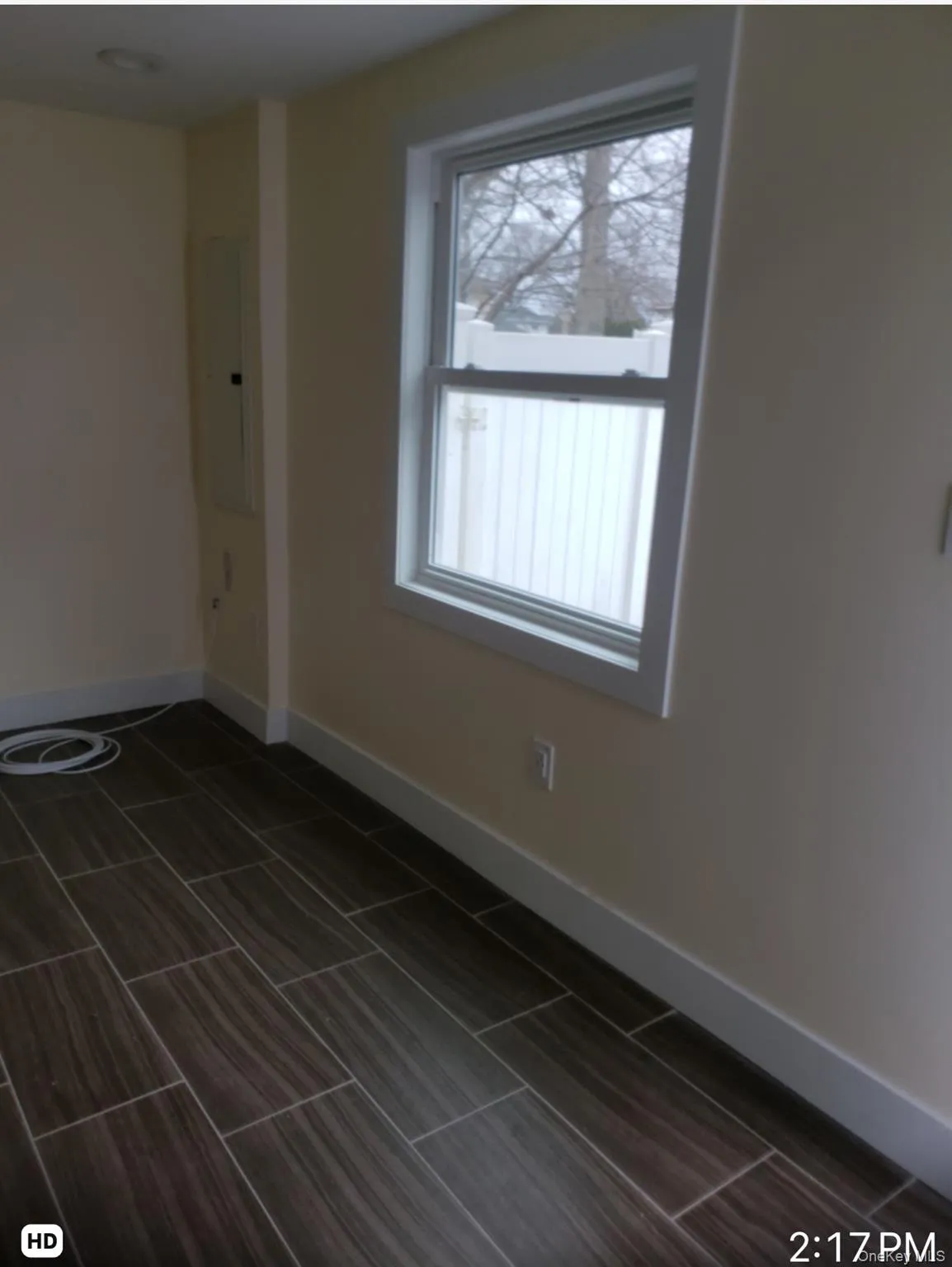Empty room featuring electric panel and wood finish floors Empty room featuring electric panel and wood finish floors