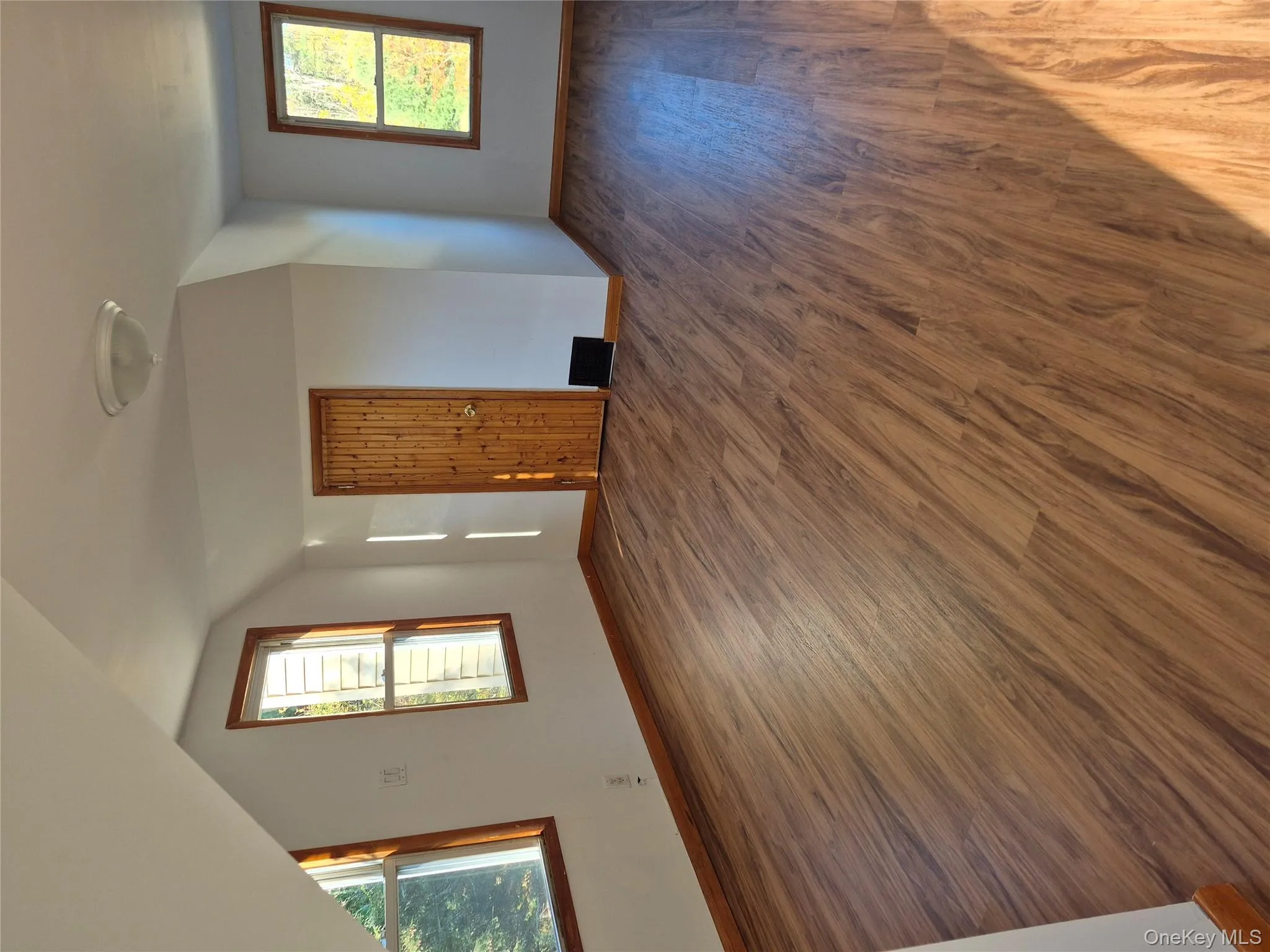 Additional living space with wood finished floors, healthy amount of natural light, and lofted ceiling Additional living space with wood finished floors, healthy amount of natural light, and lofted ceiling