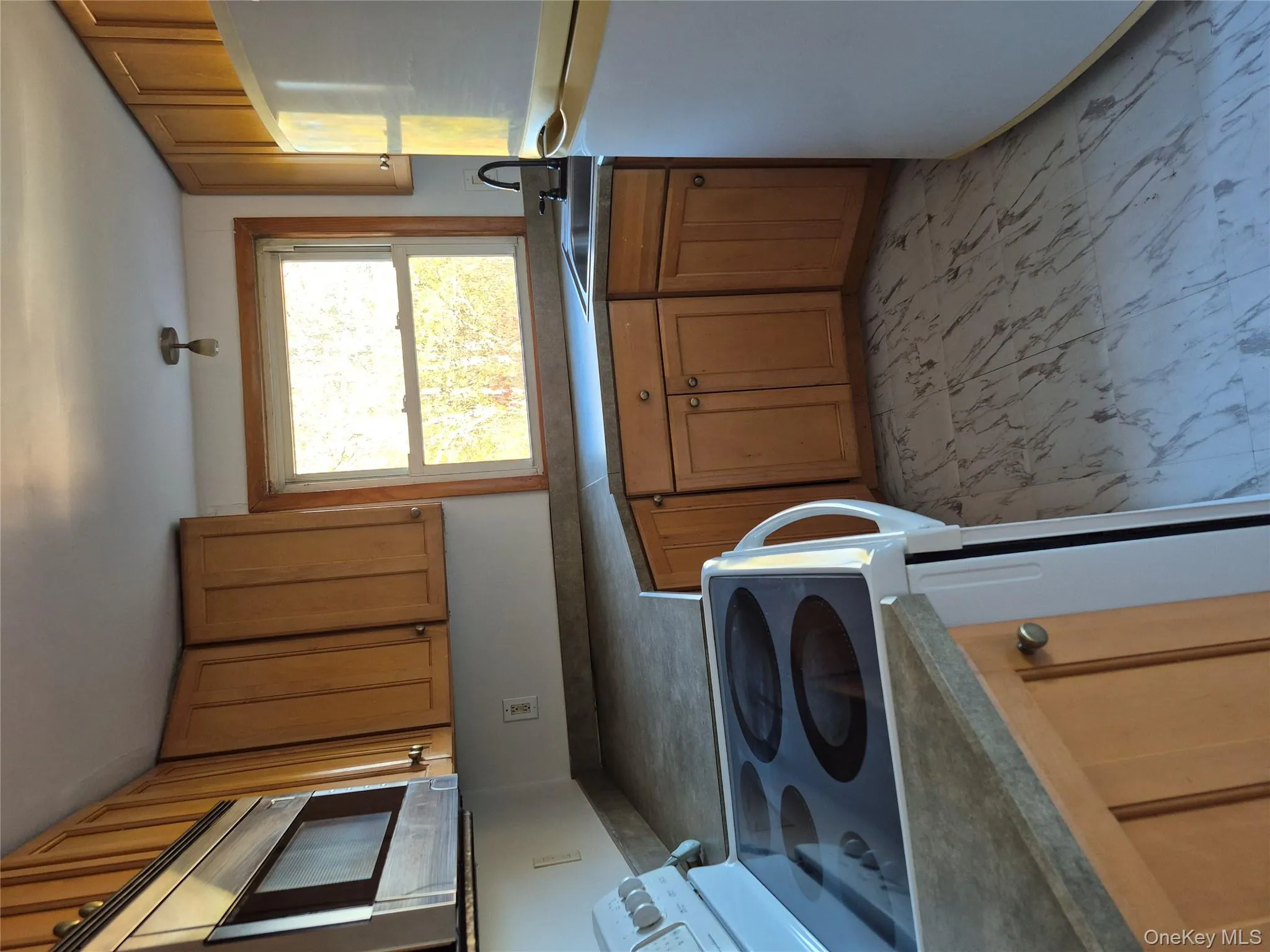 Kitchen with stainless steel range, fridge, and brown cabinets Kitchen with stainless steel range, fridge, and brown cabinets