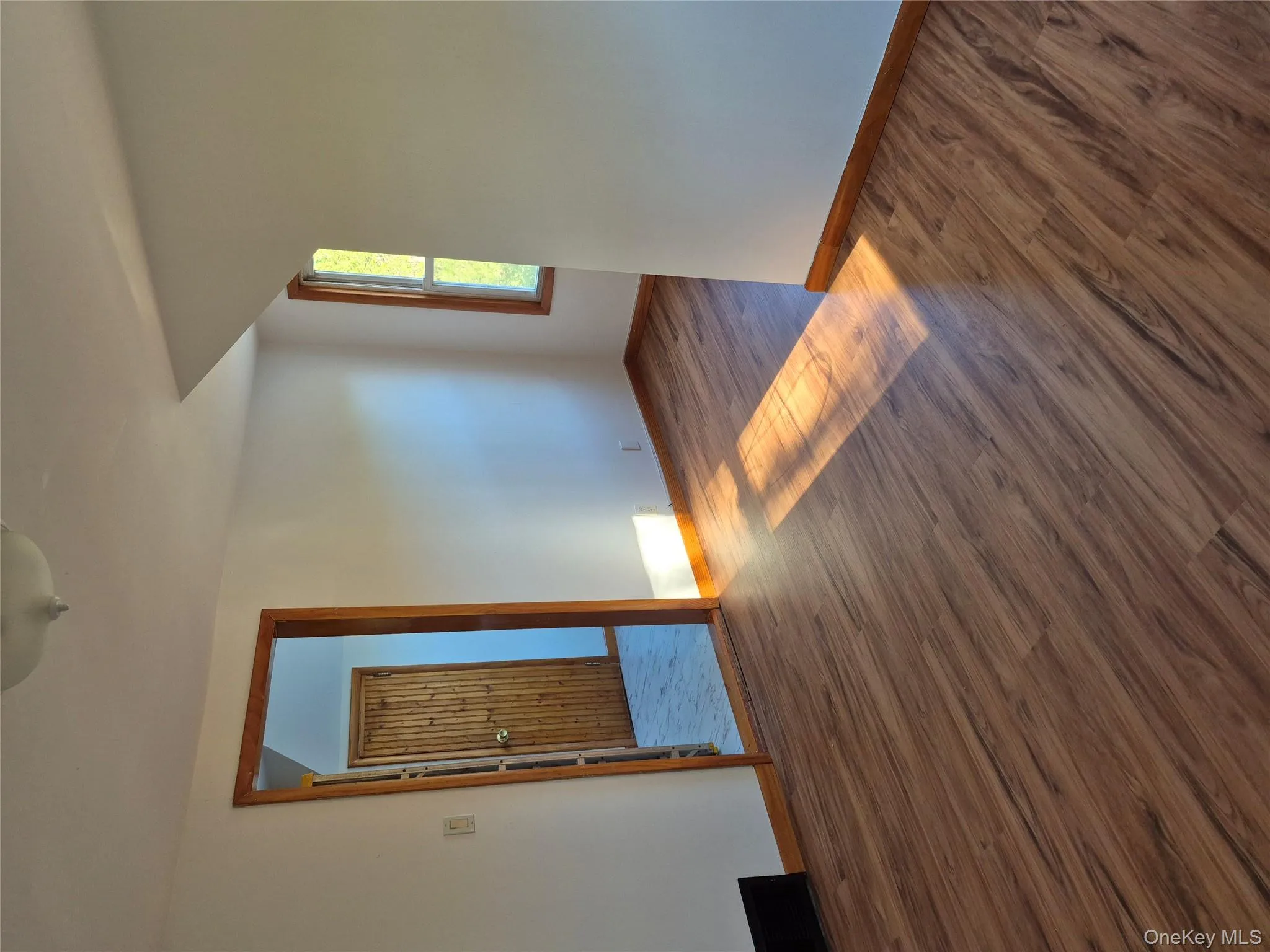Empty room featuring dark wood finished floors and baseboards Empty room featuring dark wood finished floors and baseboards