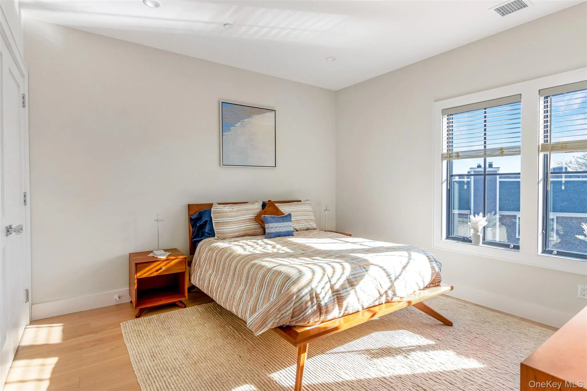 Bedroom with light wood finished floors and baseboards Bedroom with light wood finished floors and baseboards