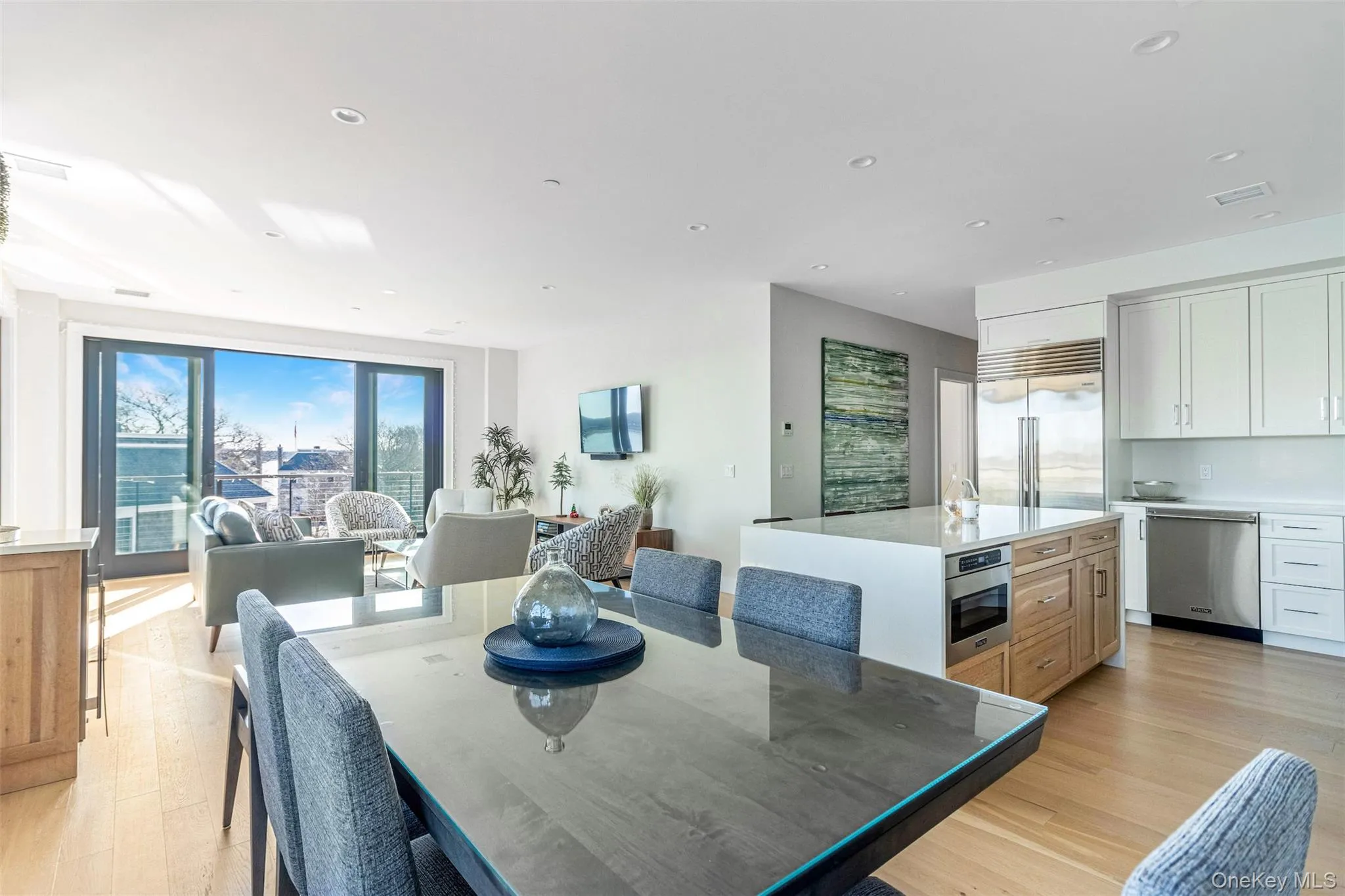 Dining room with light wood-style flooring and recessed lighting Dining room with light wood-style flooring and recessed lighting