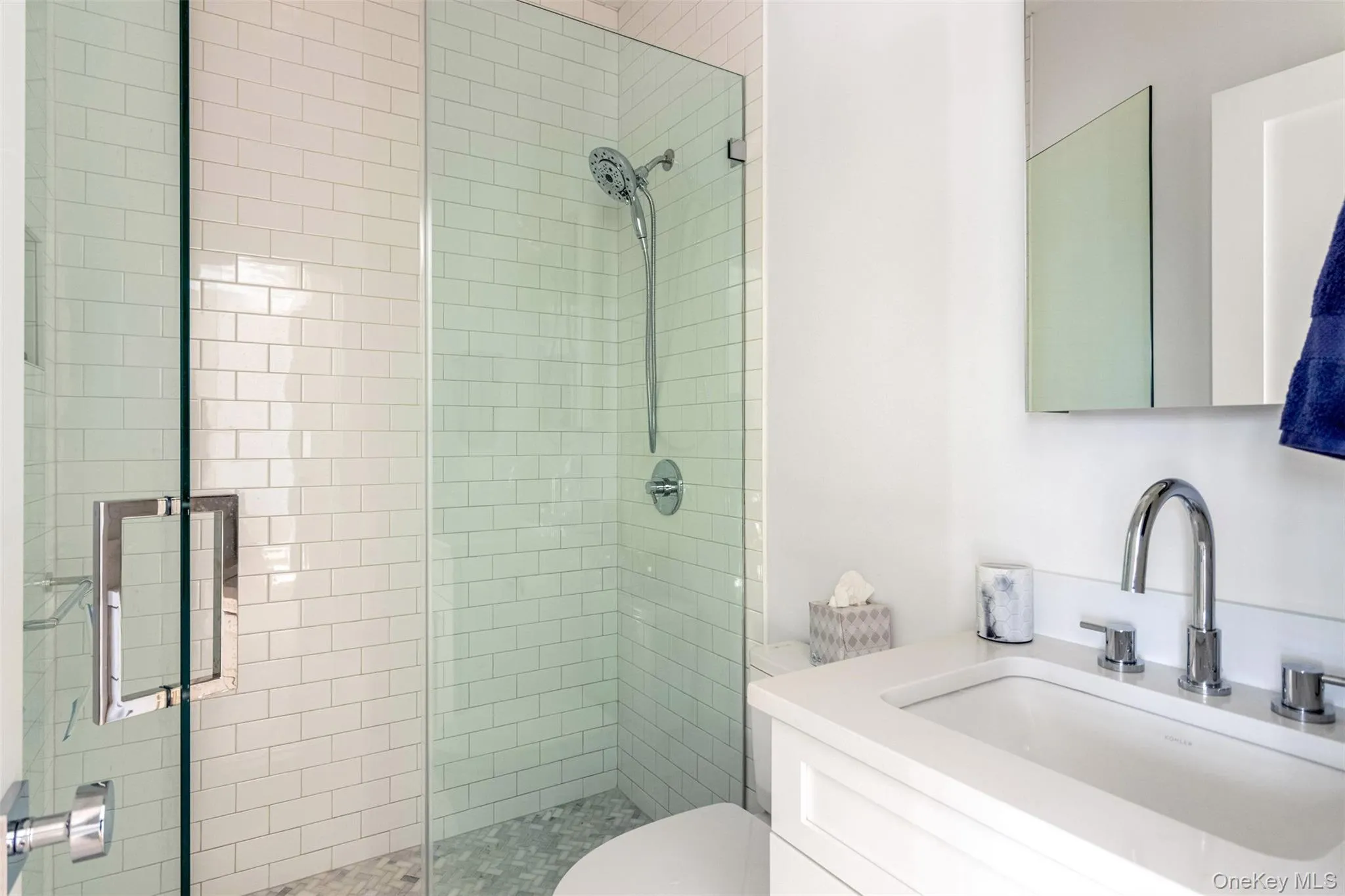 Full bath featuring vanity and tiled shower Full bath featuring vanity and tiled shower
