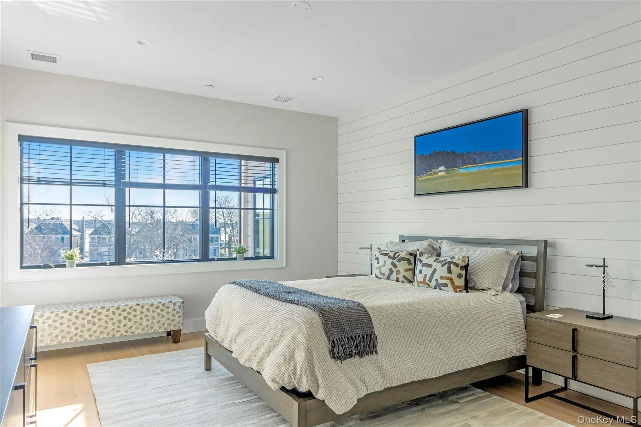 Bedroom featuring light wood-style floors, wood walls, and recessed lighting Bedroom featuring light wood-style floors, wood walls, and recessed lighting