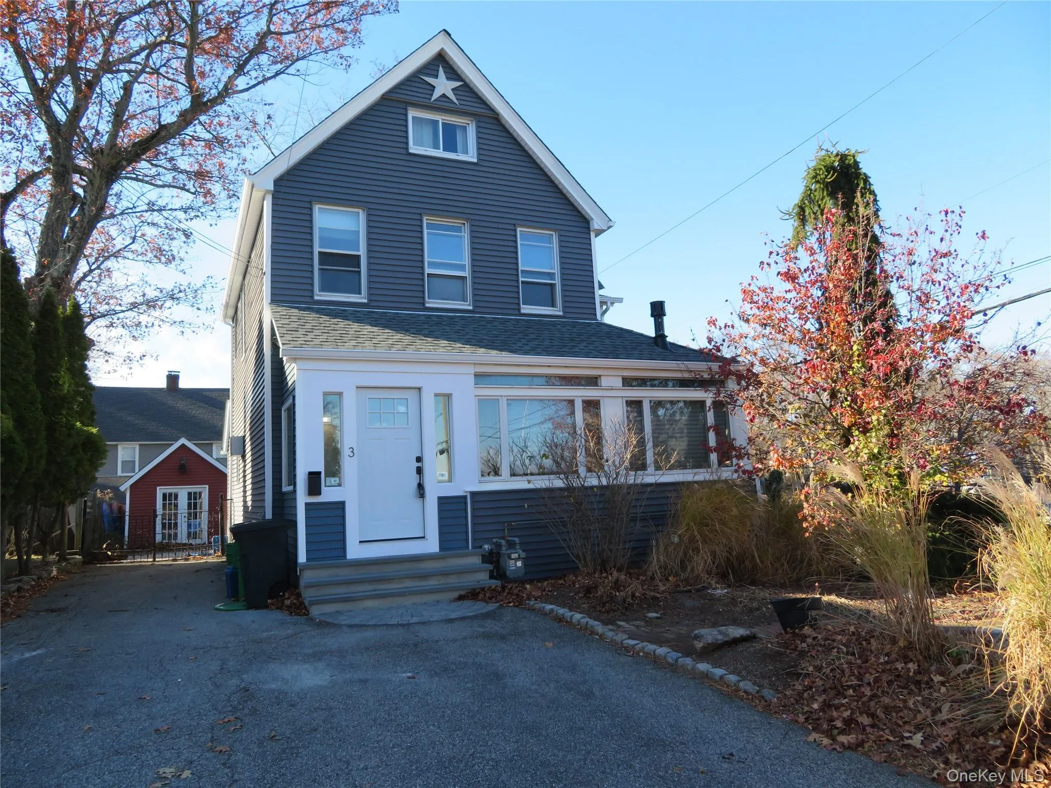 View of front facade featuring roof with shingles, driveway, and entry steps View of front facade featuring roof with shingles, driveway, and entry steps