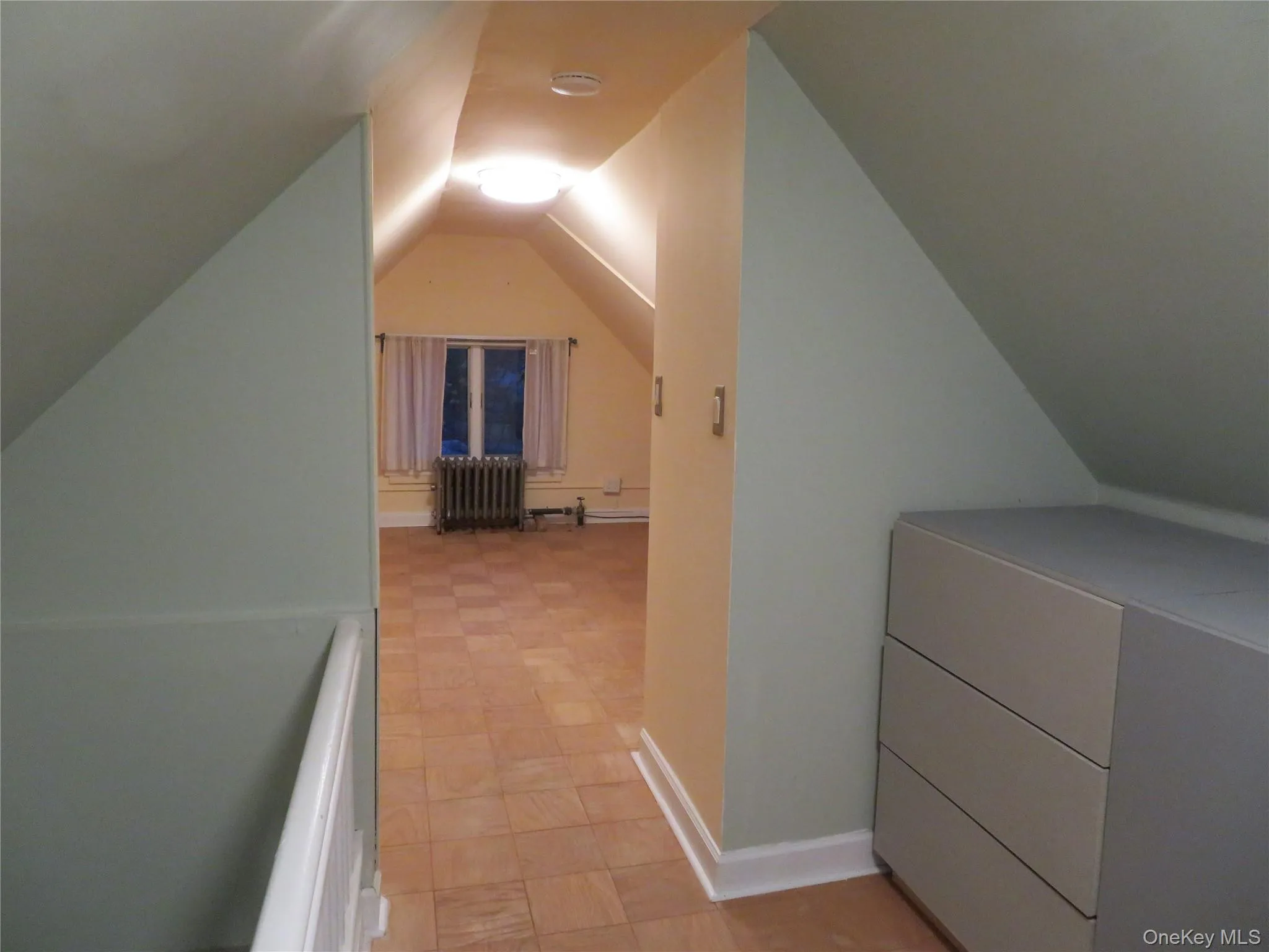 Additional living space with radiator heating unit and vaulted ceiling Additional living space with radiator heating unit and vaulted ceiling