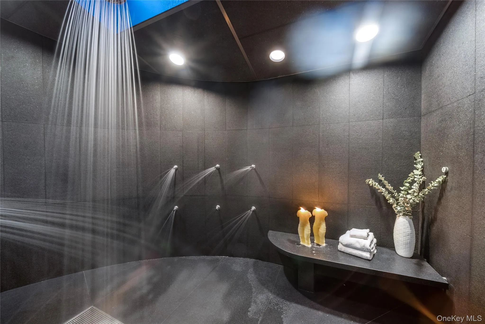An Expansive Walk-in Steam Shower With Multiple Shower Heads An Expansive Walk-in Steam Shower With Multiple Shower Heads
