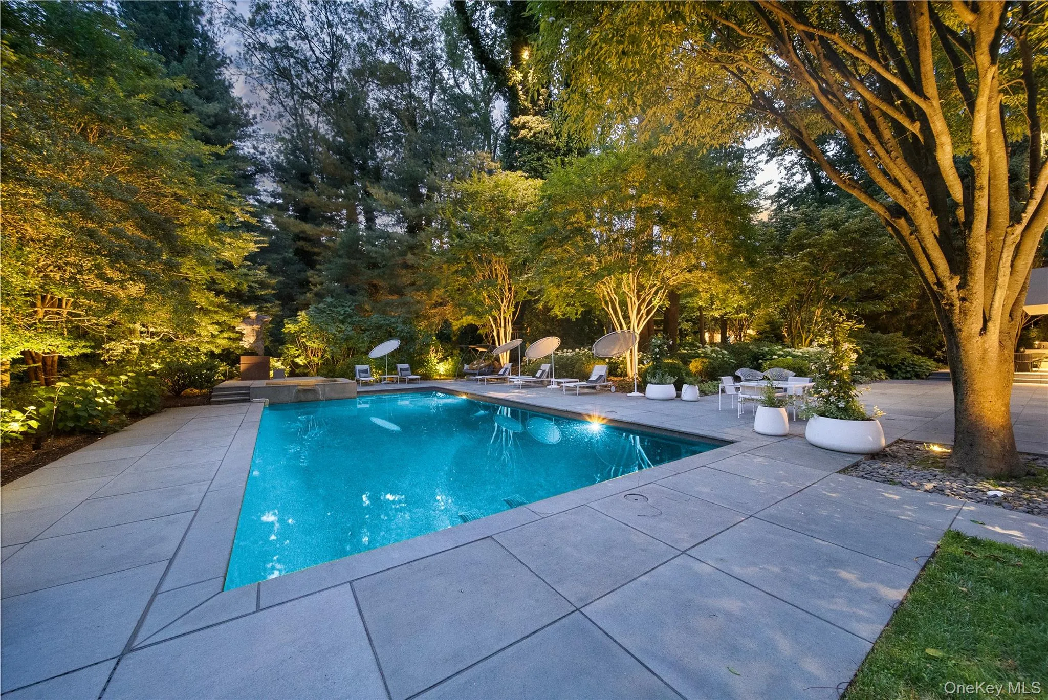 View of pool featuring a patio and a pool with connected hot tub View of pool featuring a patio and a pool with connected hot tub