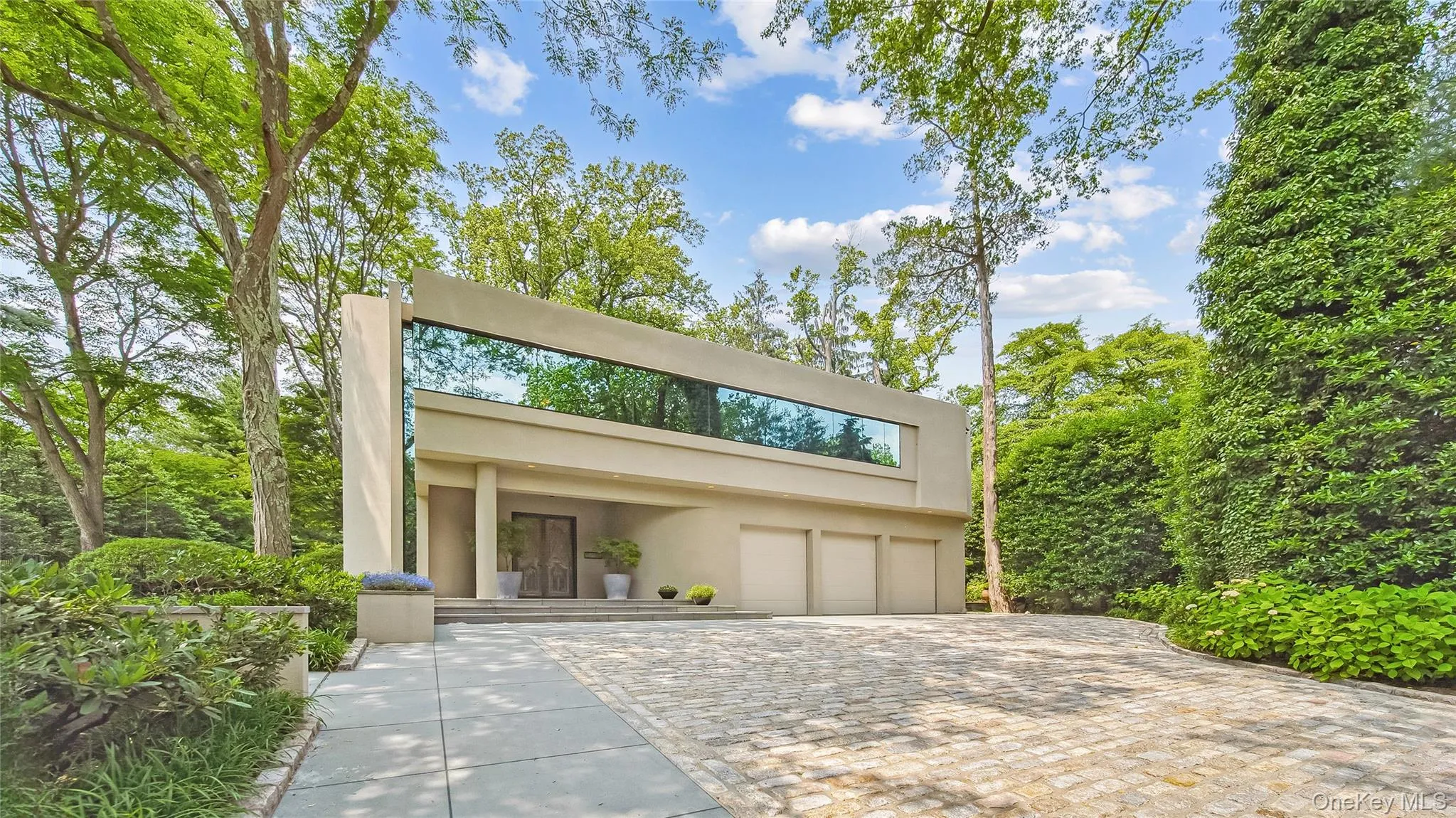 The Home Was Designed To Create A Nature Preserve With Maximum Privacy. Continuous Solar Green Glazing Mirrors The Trees and Reinforces The Horizontal Rhythm of The Structure Along With A 3-Car Garage and Limestone Walking Paths The Home Was Designed To Create A Nature Preserve With Maximum Privacy. Continuous Solar Green Glazing Mirrors The Trees and Reinforces The Horizontal Rhythm of The Structure Along With A 3-Car Garage and Limestone Walking Paths