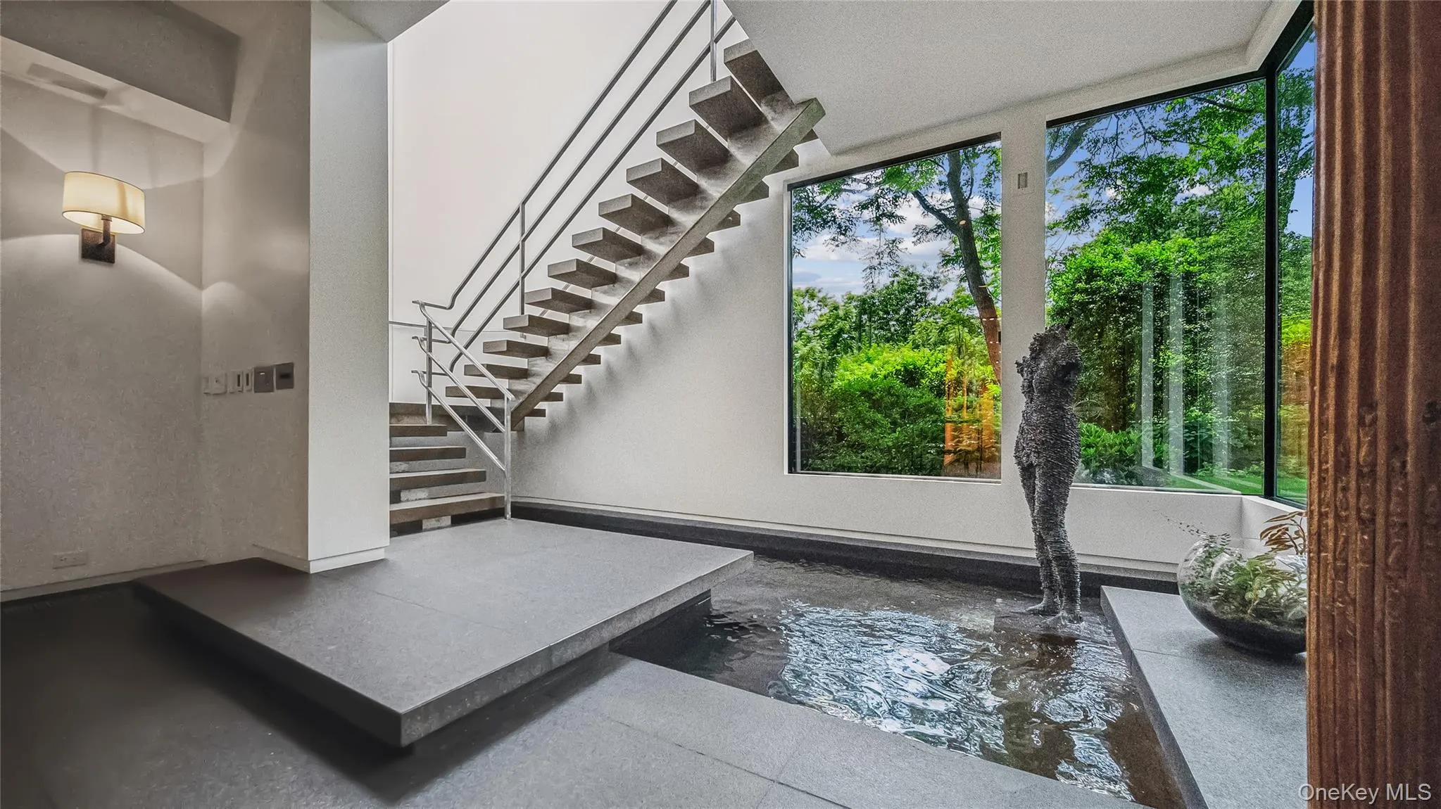 Entry Foyer is Graced By A Stainless Steel Floating Staircase Entry Foyer is Graced By A Stainless Steel Floating Staircase