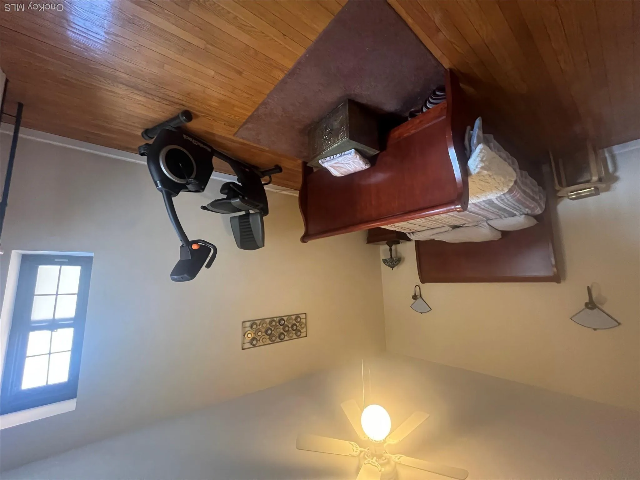 Bedroom with hardwood flooring and ceiling fan Bedroom with hardwood flooring and ceiling fan