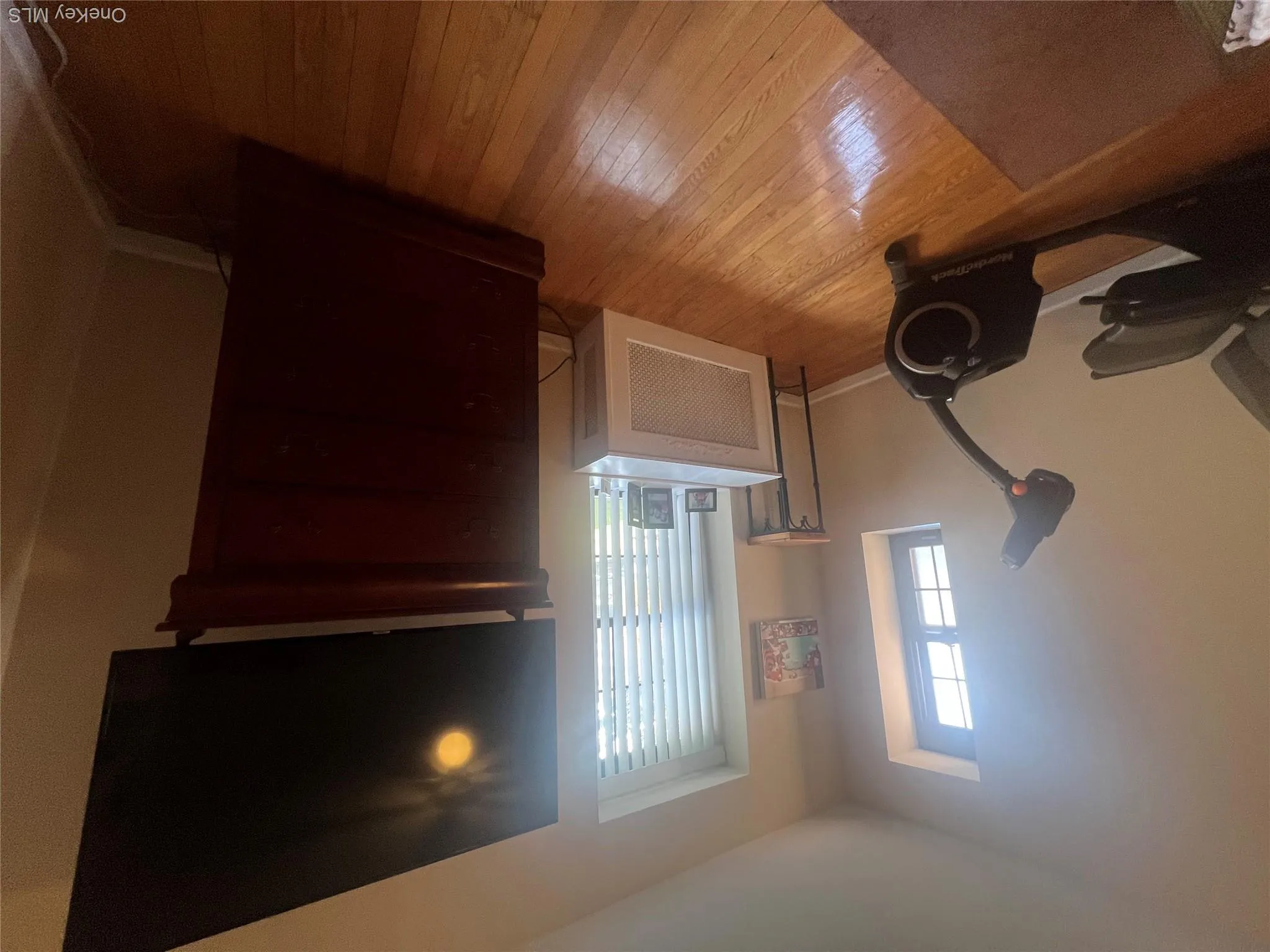 Bedroom featuring radiator and light wood-style floors Bedroom featuring radiator and light wood-style floors