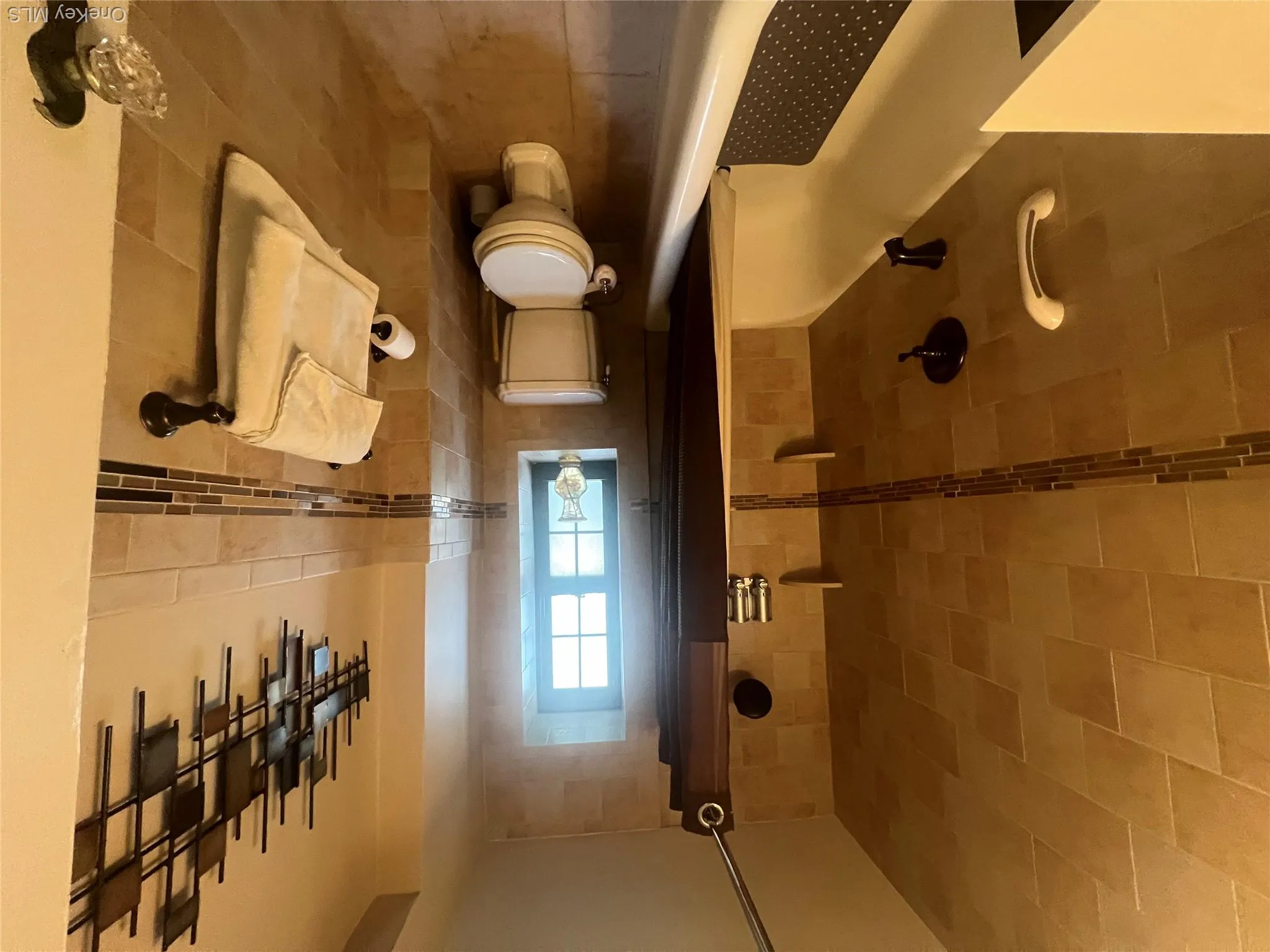 Full bathroom with tile walls, shower / bathtub combination with curtain, vanity, and tile patterned floors Full bathroom with tile walls, shower / bathtub combination with curtain, vanity, and tile patterned floors