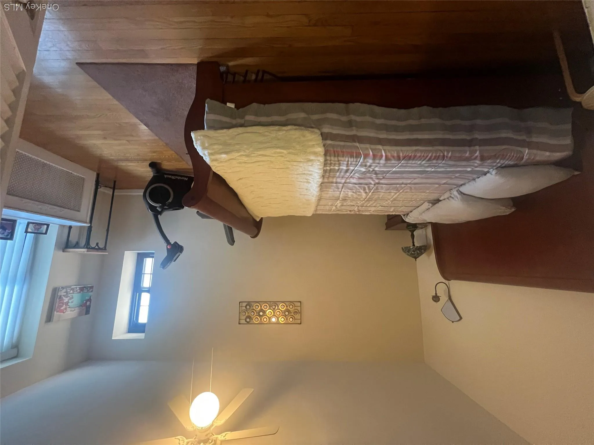 Bedroom with hardwood floors and ceiling fan Bedroom with hardwood floors and ceiling fan