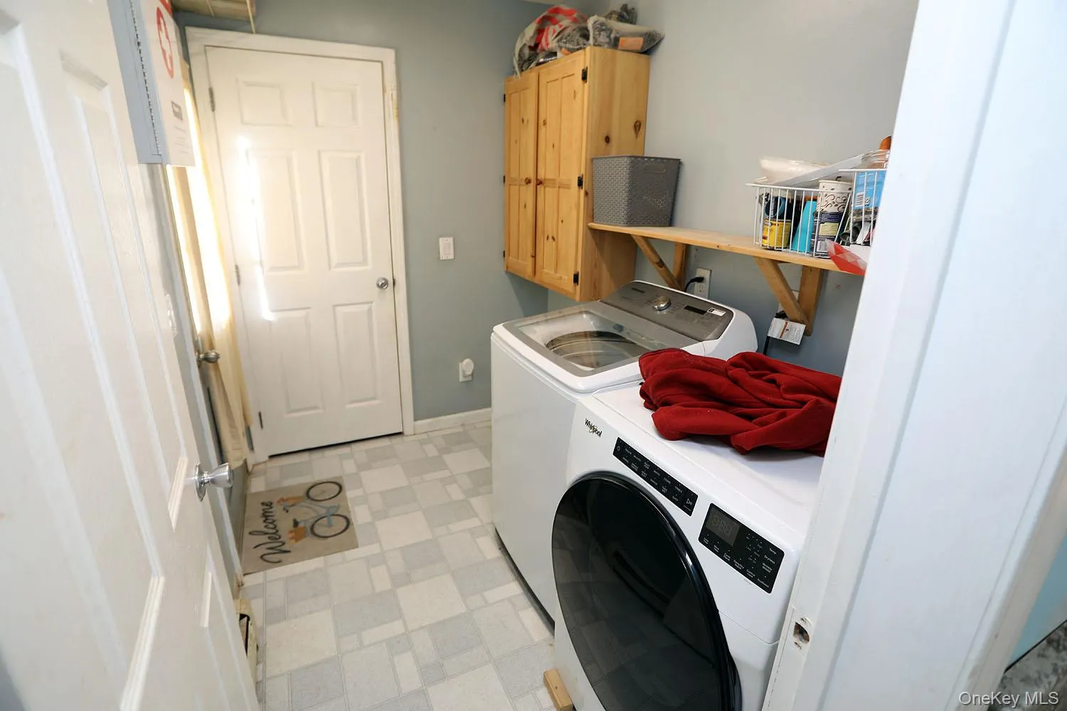 Laundry area with washer and dryer, light flooring, and cabinet space Laundry area with washer and dryer, light flooring, and cabinet space