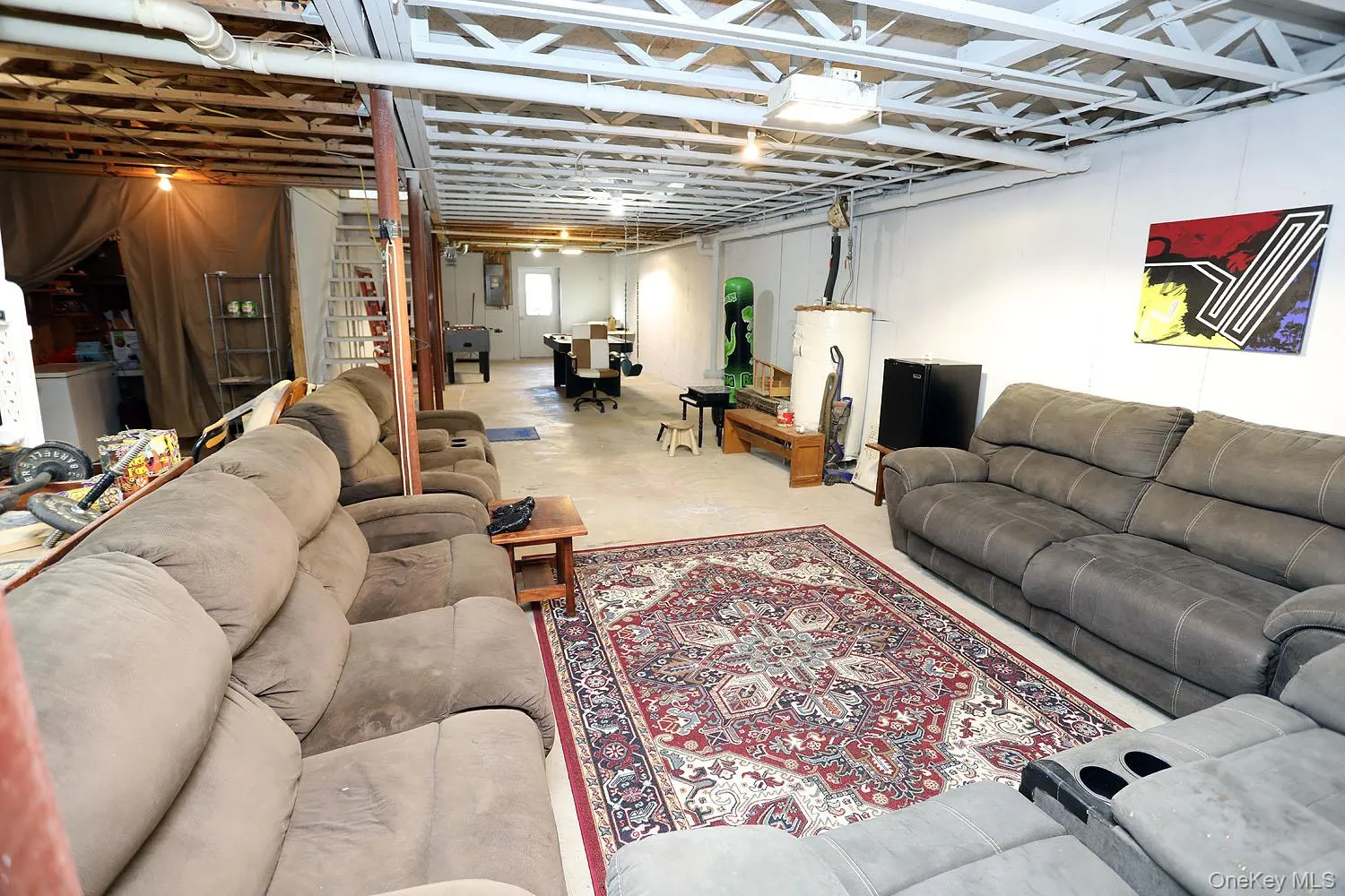 Living room with water heater and concrete flooring Living room with water heater and concrete flooring