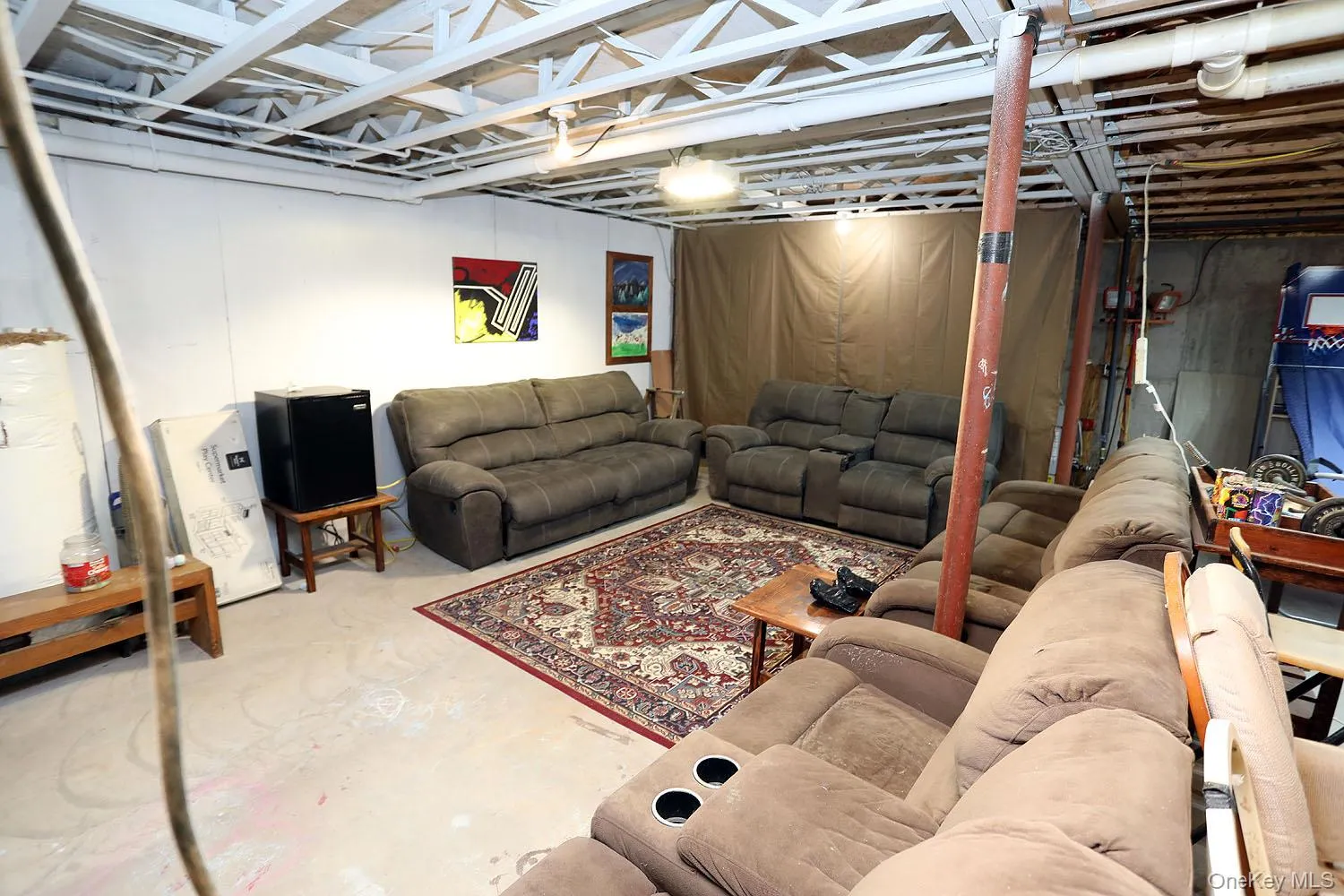Living room featuring unfinished concrete floors Living room featuring unfinished concrete floors
