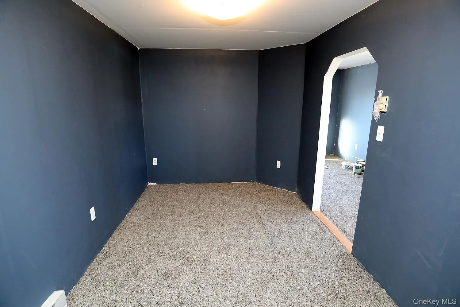 Bedroom in apartment featuring arched entry Bedroom in apartment featuring arched entry
