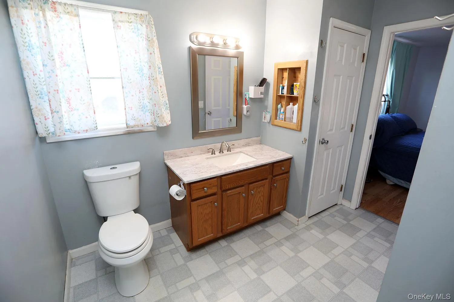 Ensuite bathroom featuring vanity and light flooring Ensuite bathroom featuring vanity and light flooring
