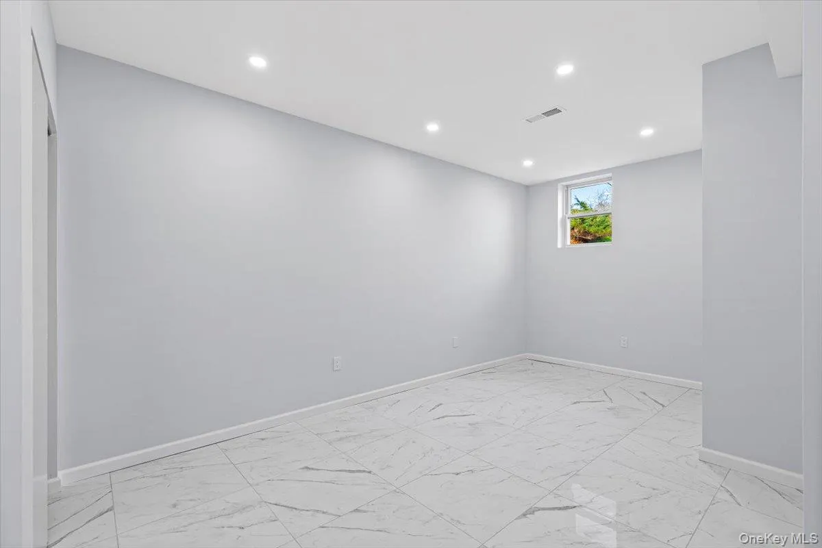 Spare room featuring light marble finish flooring and recessed lighting Spare room featuring light marble finish flooring and recessed lighting