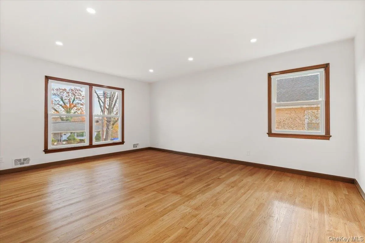 Unfurnished room with light wood-type flooring, recessed lighting, and healthy amount of natural light Unfurnished room with light wood-type flooring, recessed lighting, and healthy amount of natural light