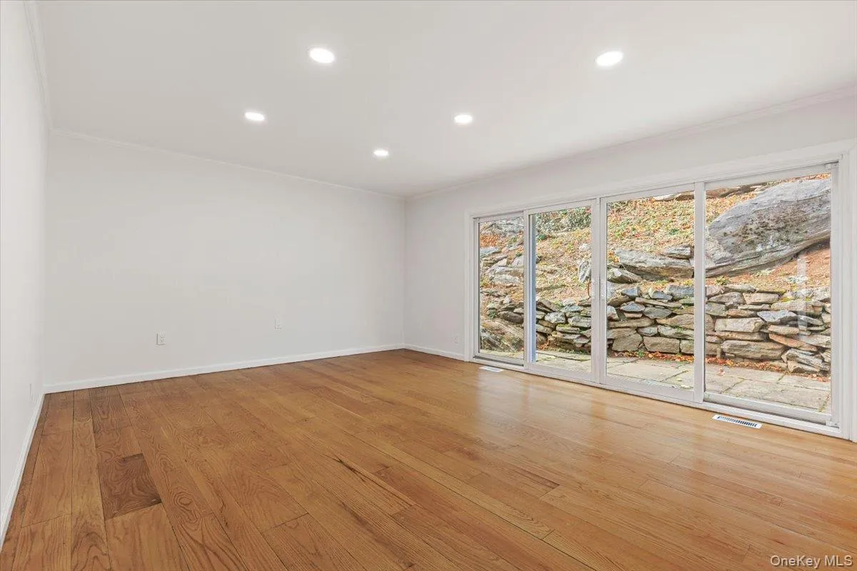 Unfurnished room featuring recessed lighting, ornamental molding, and light wood-style flooring Unfurnished room featuring recessed lighting, ornamental molding, and light wood-style flooring