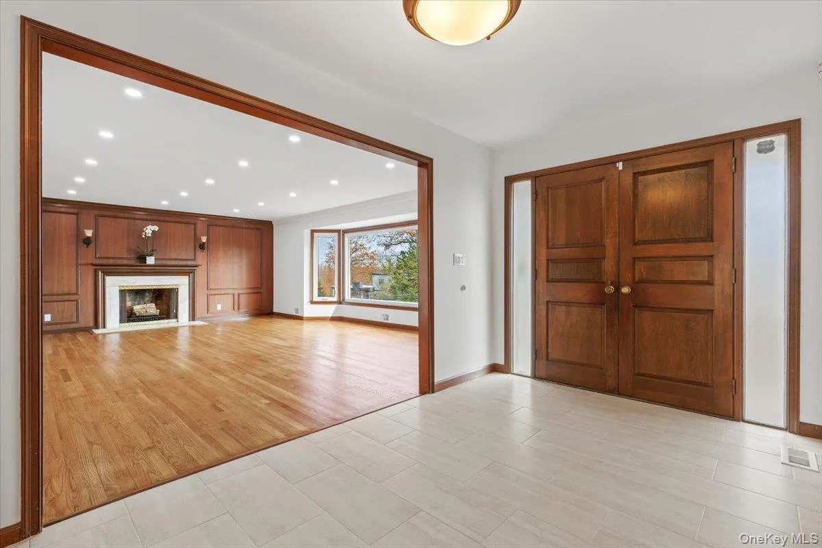 Foyer with recessed lighting, light wood-style floors, and a premium fireplace Foyer with recessed lighting, light wood-style floors, and a premium fireplace