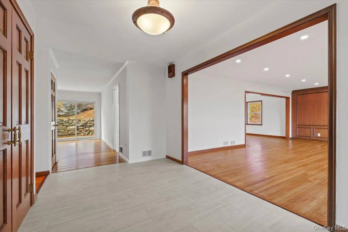 Unfurnished room featuring light wood-style flooring, crown molding, and recessed lighting Unfurnished room featuring light wood-style flooring, crown molding, and recessed lighting